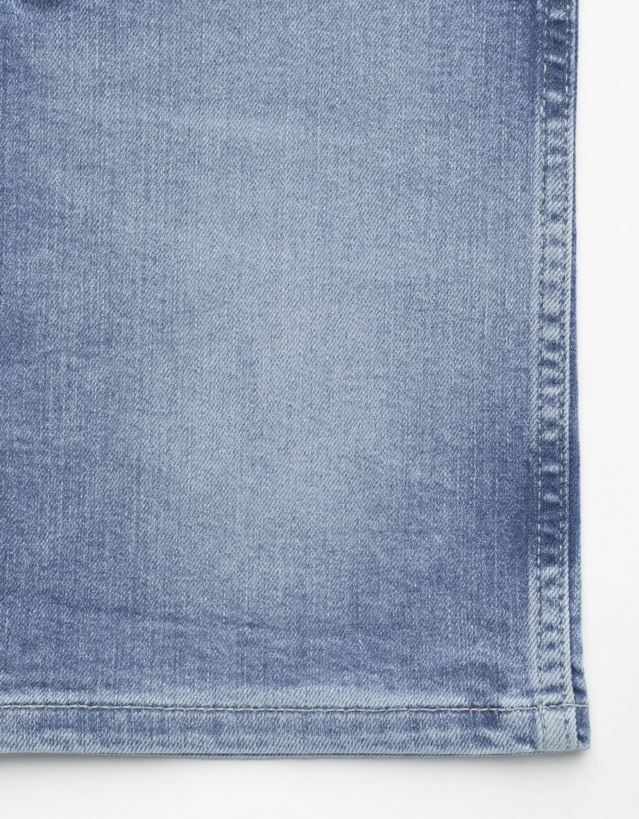 Light blue denim jeans by bugatti, close-up of fabric texture, casual and stylish.