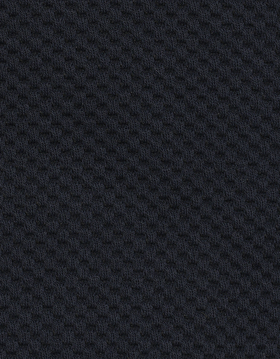 Dark blue fabric with textured honeycomb pattern, close-up, ideal for bugatti fashion.