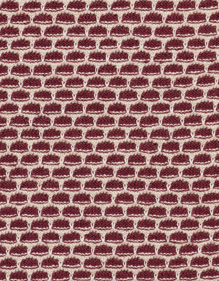 Red and white knit pattern, tightly woven, textured, close-up detail.