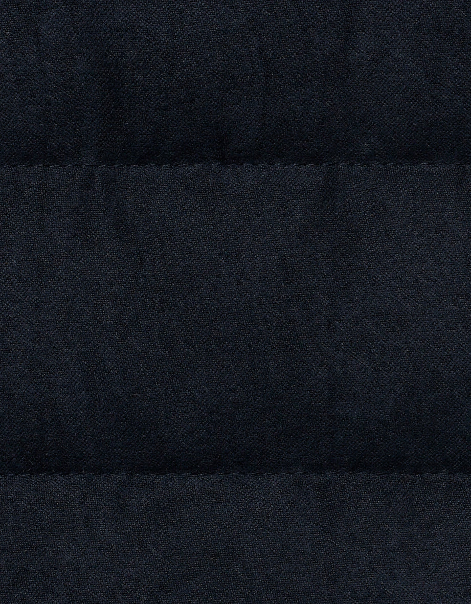 Dark blue quilted fabric by bugatti, detailed texture, high-quality craftsmanship.