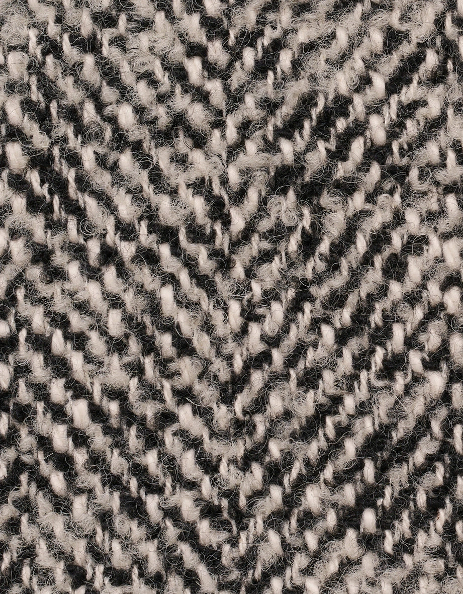 Textur eines schwarz-cremefarbenen Strickmusters, Detailaufnahme.