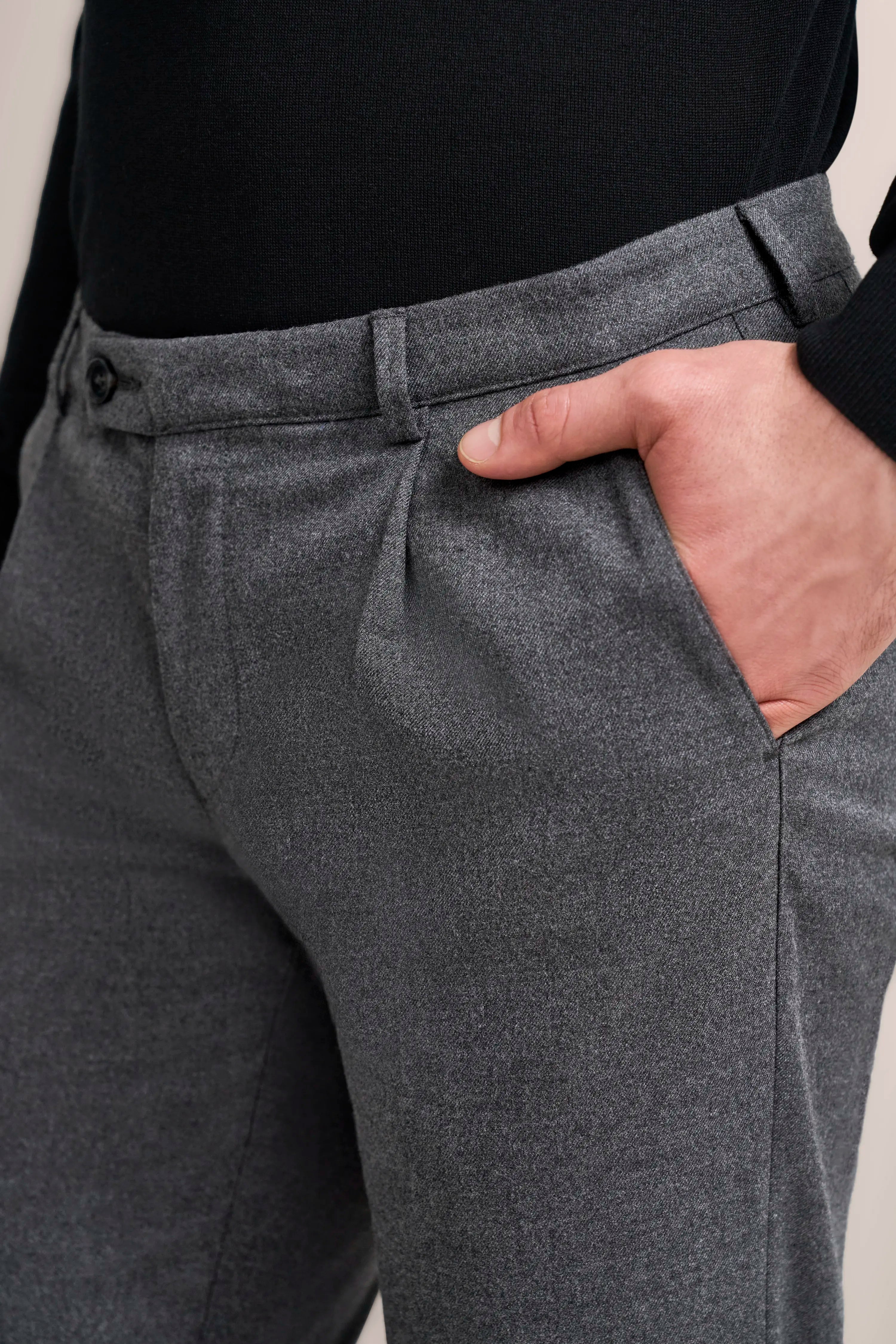 Grey bugatti pants, close-up, casual design, hand in pocket, timeless style.