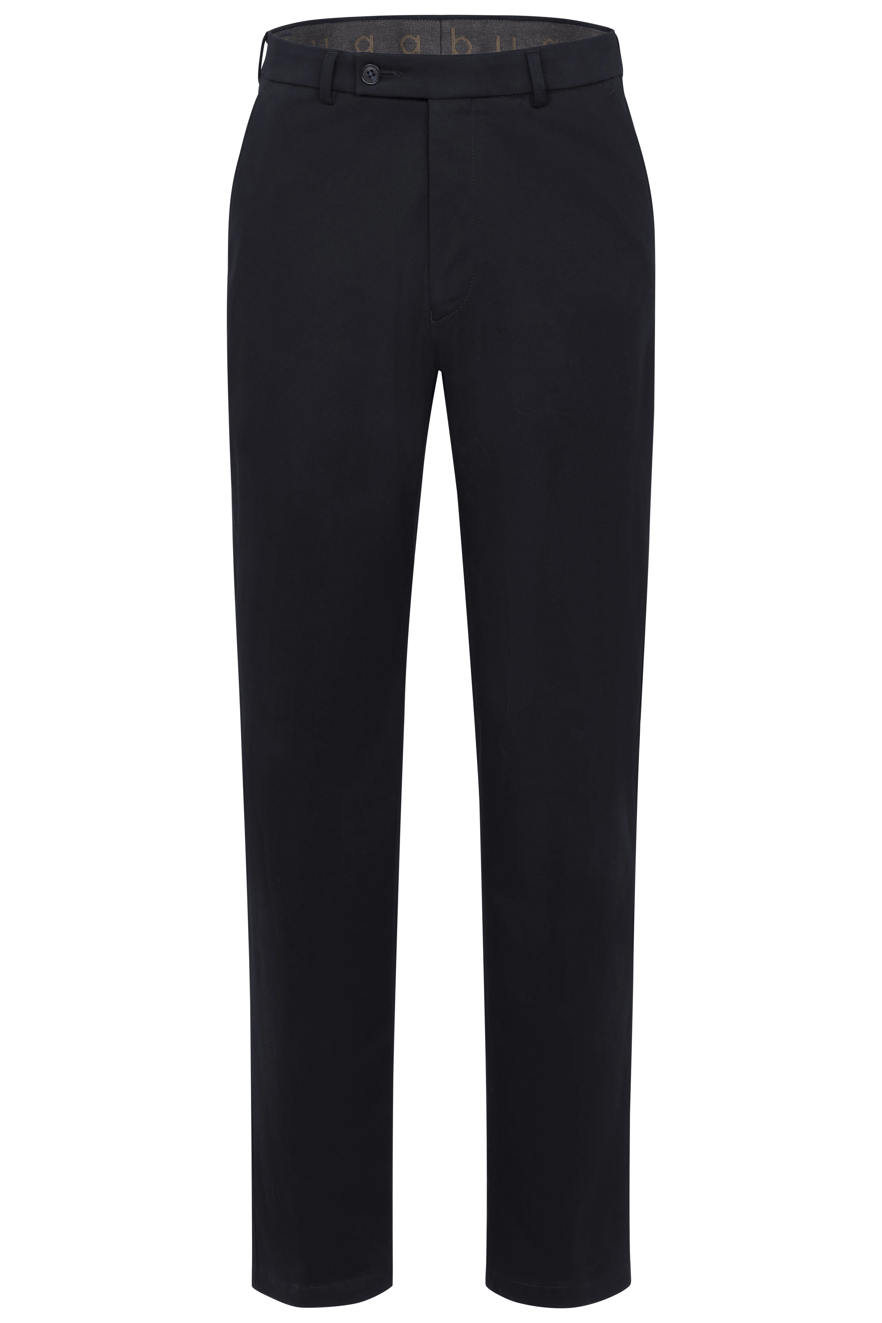 Back view of a casual outfit with navy pants and sweater, model stands relaxed.