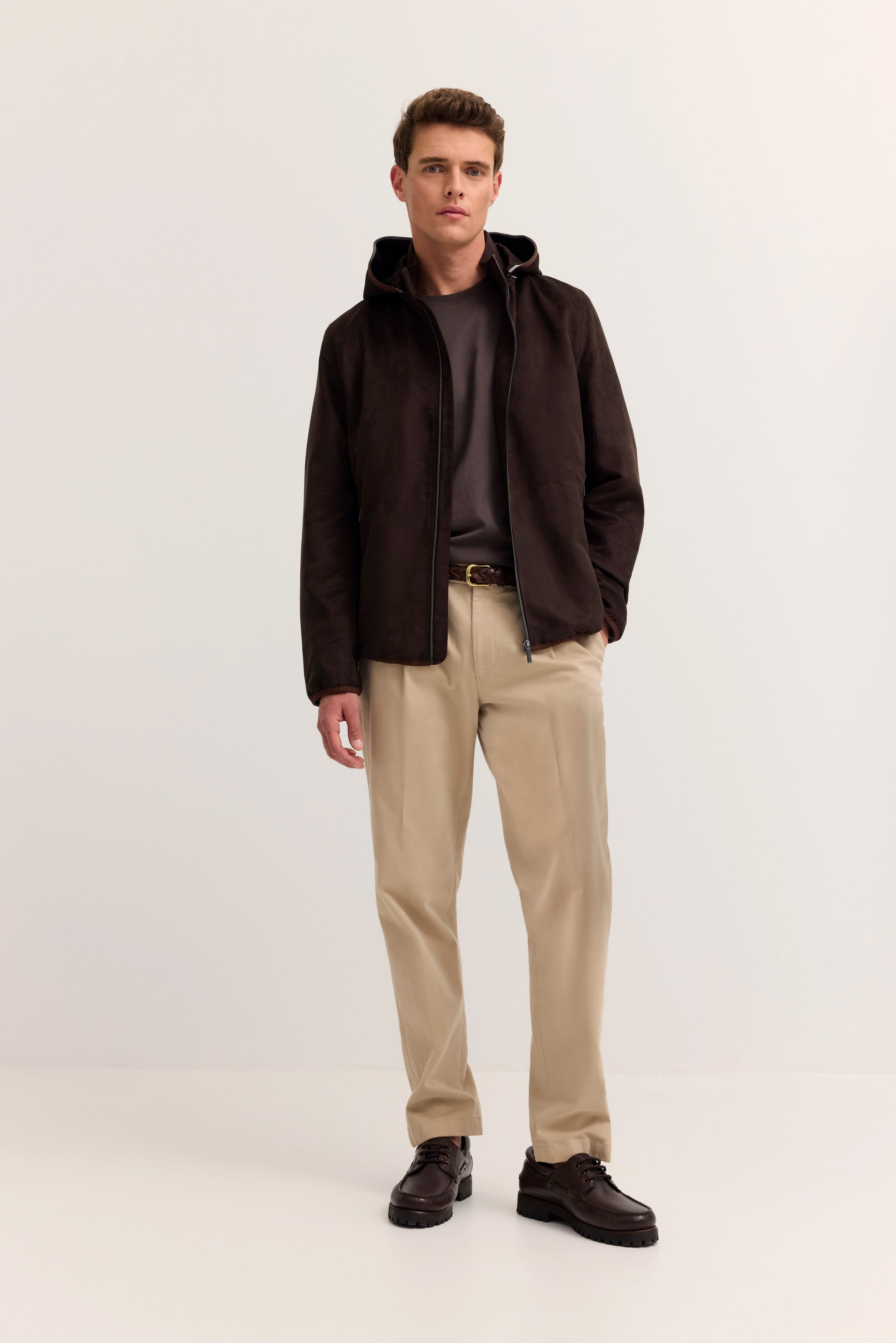 Bugatti braune Jacke, perforiertes Design, Modelbild, seitliches Posing, stilvoll und zeitlos.