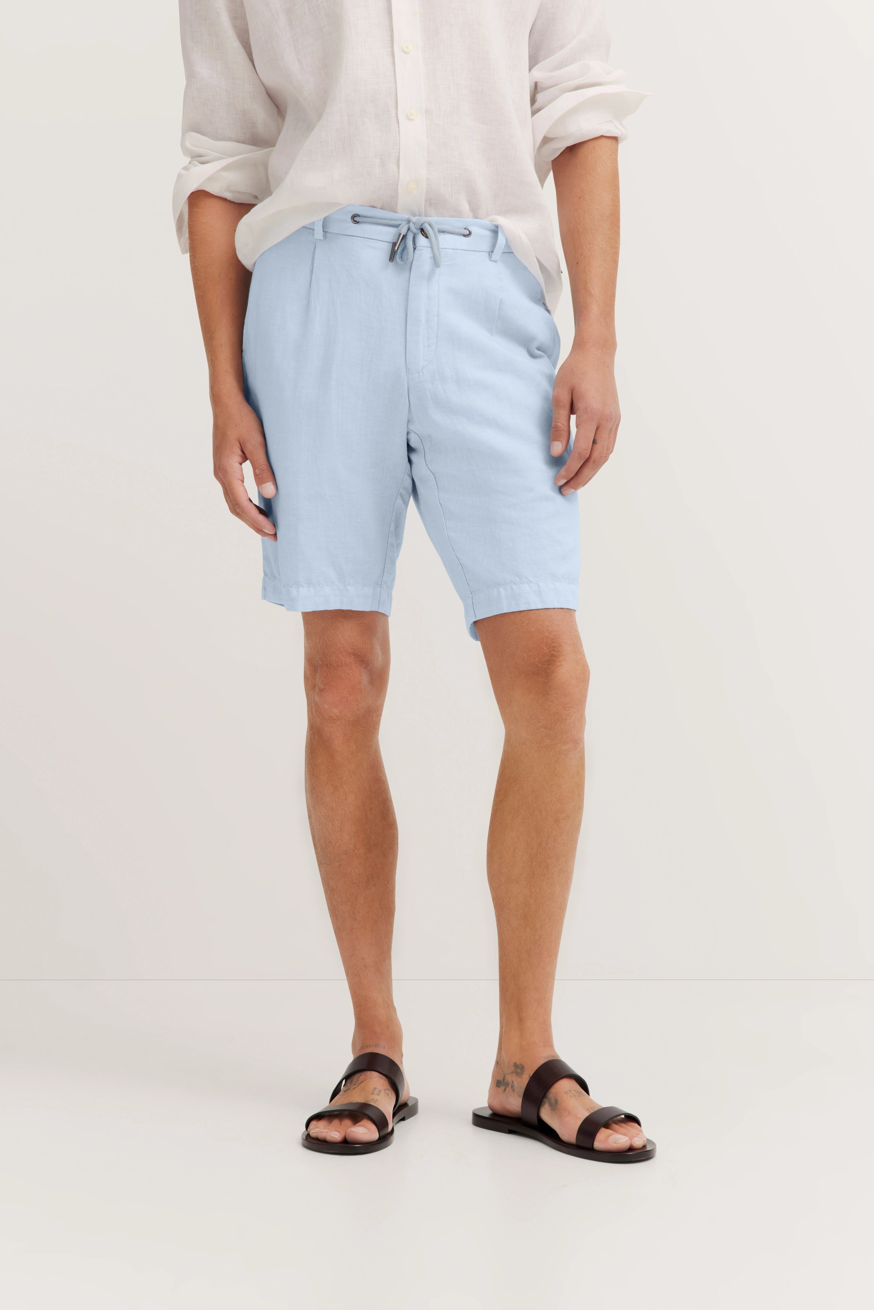 White linen shirt, light blue shorts, brown sandals by bugatti, inspired by Italian elegance and timeless style.