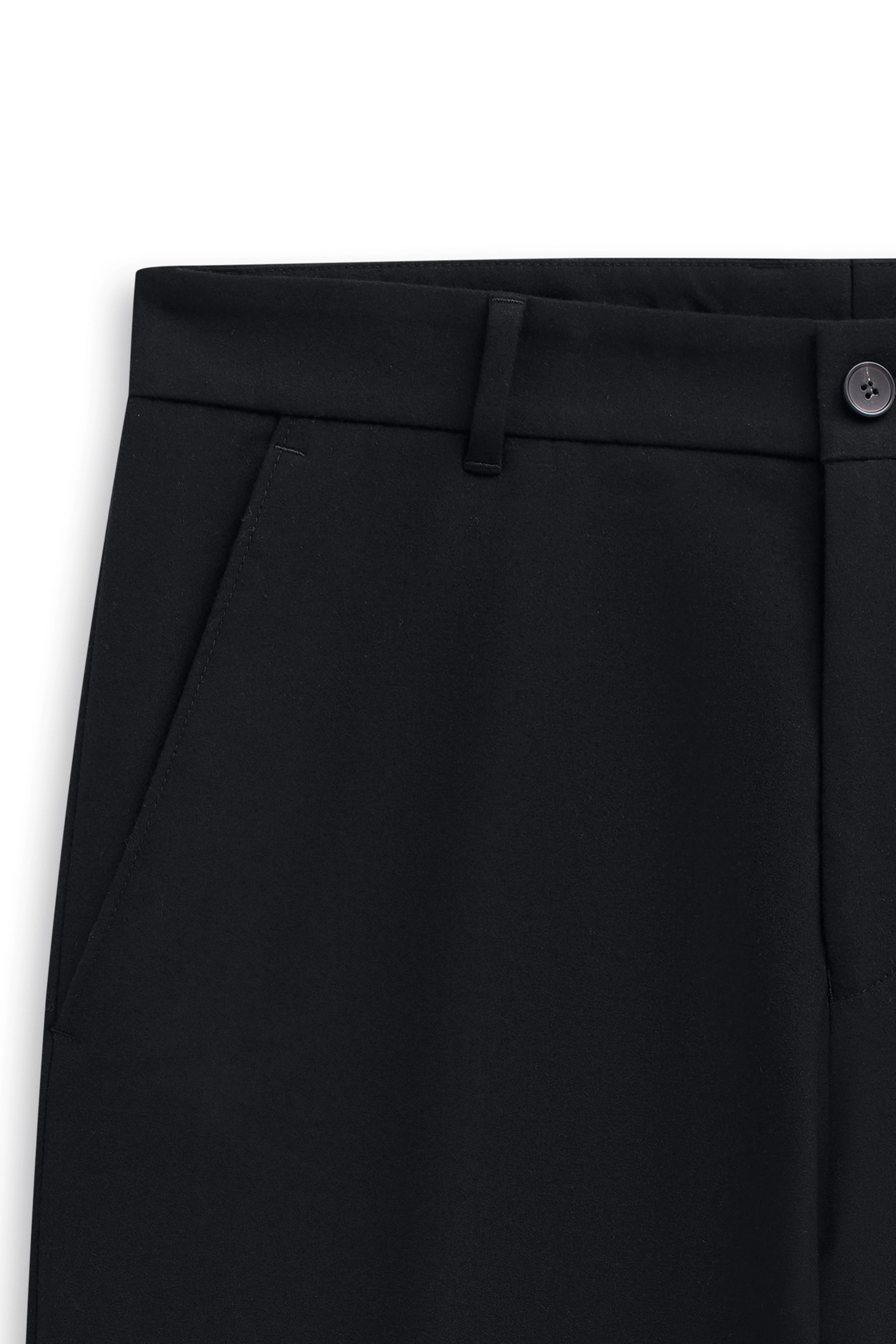 Black bugatti suit trousers, close-up, minimalist design.
