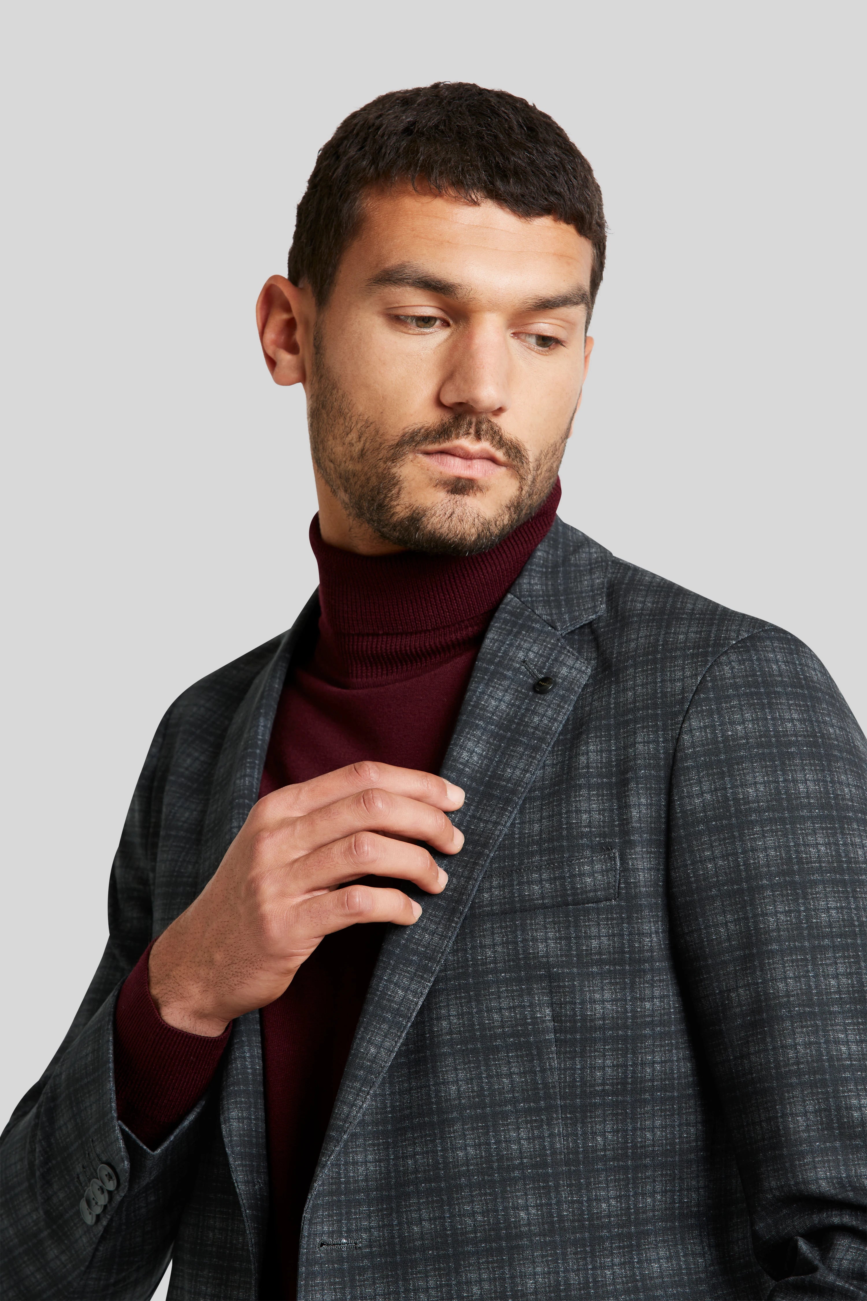 Gray checkered blazer and burgundy turtleneck, model posing relaxed, bugatti.