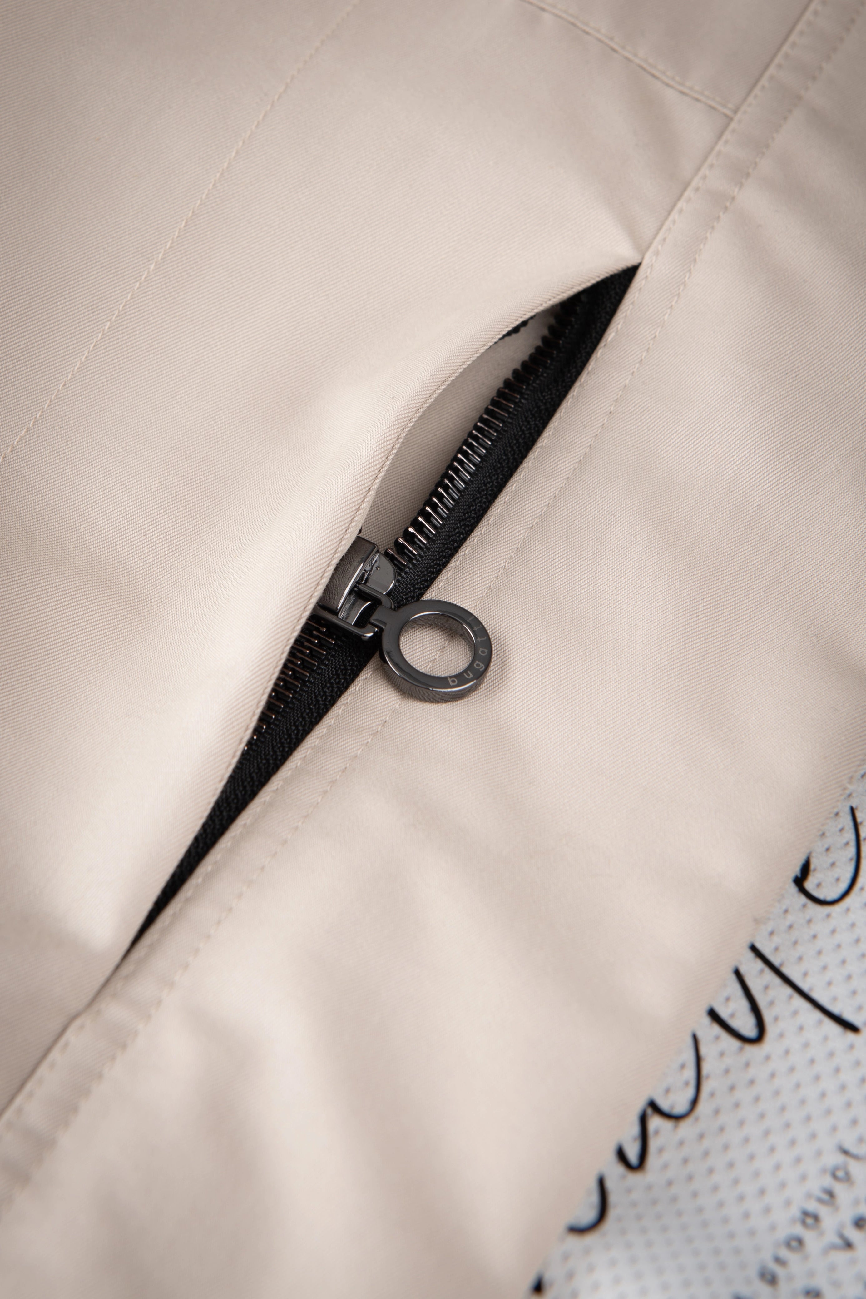 Close-up of beige bugatti coat with elegant zipper detail.