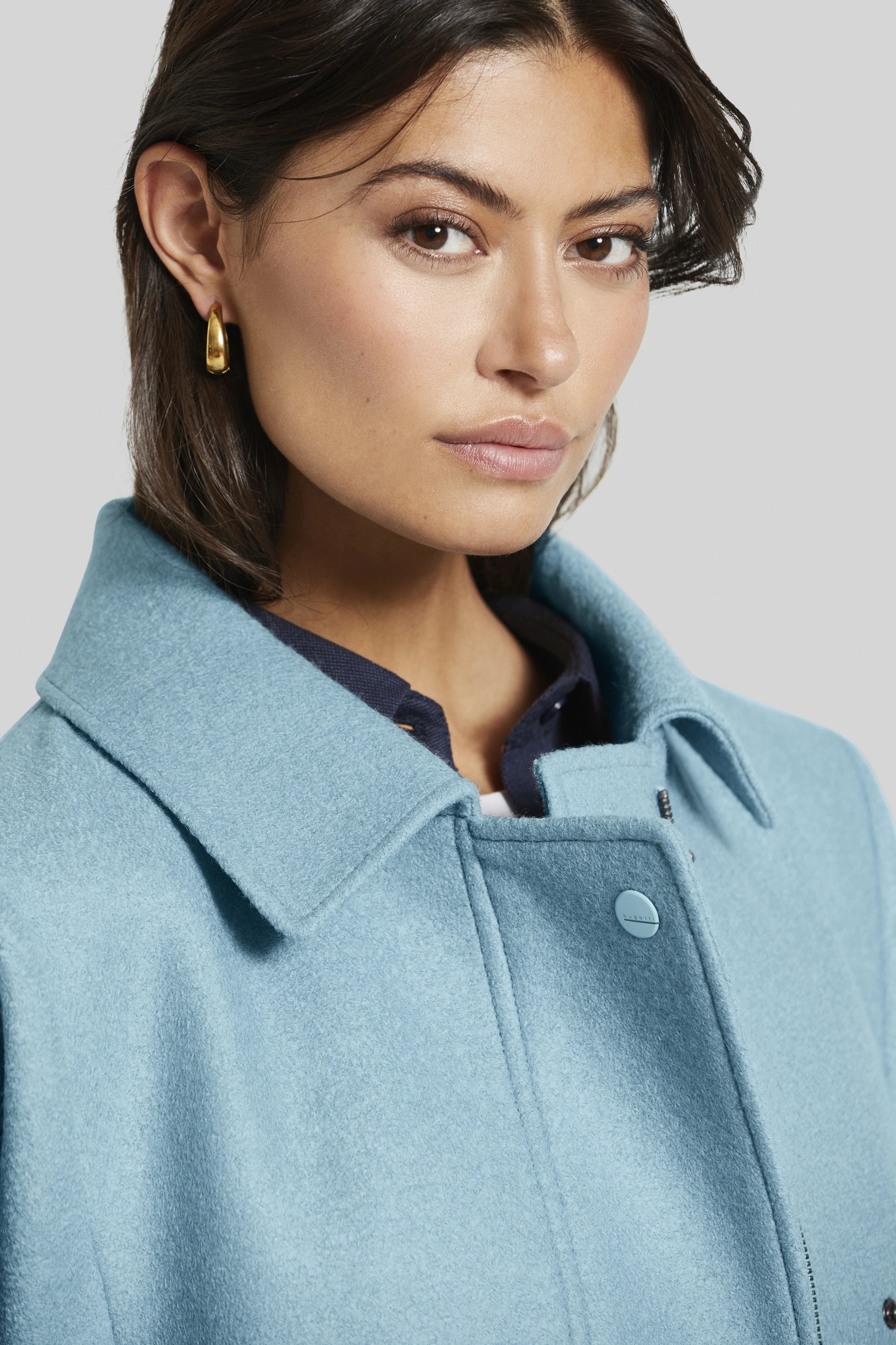 Back view of a turquoise bugatti jacket, bust image, simple design.
