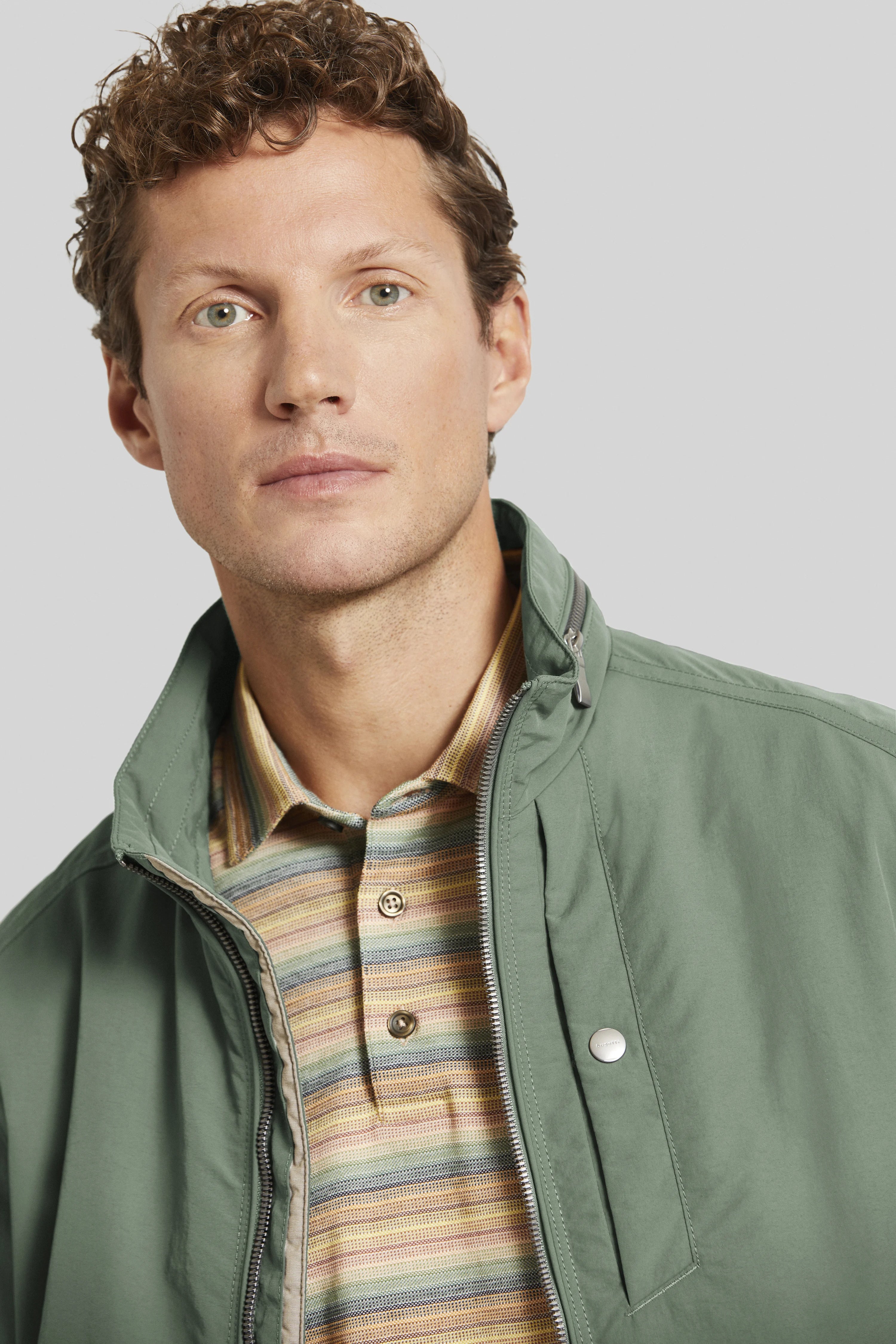 Green bugatti jacket, striped polo, model bust, relaxed look.