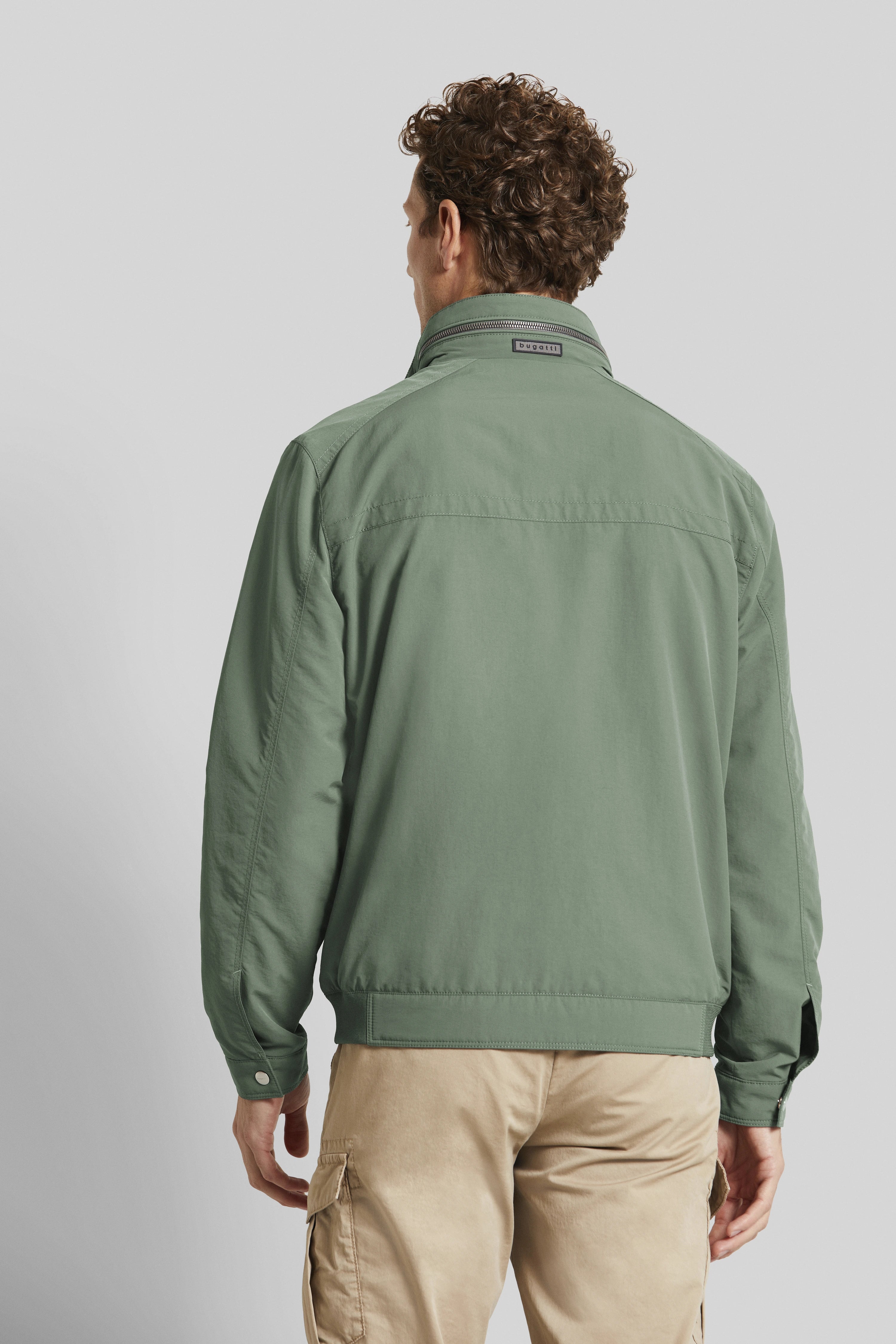 Green bugatti jacket, casual back view, paired with beige cargo pants.