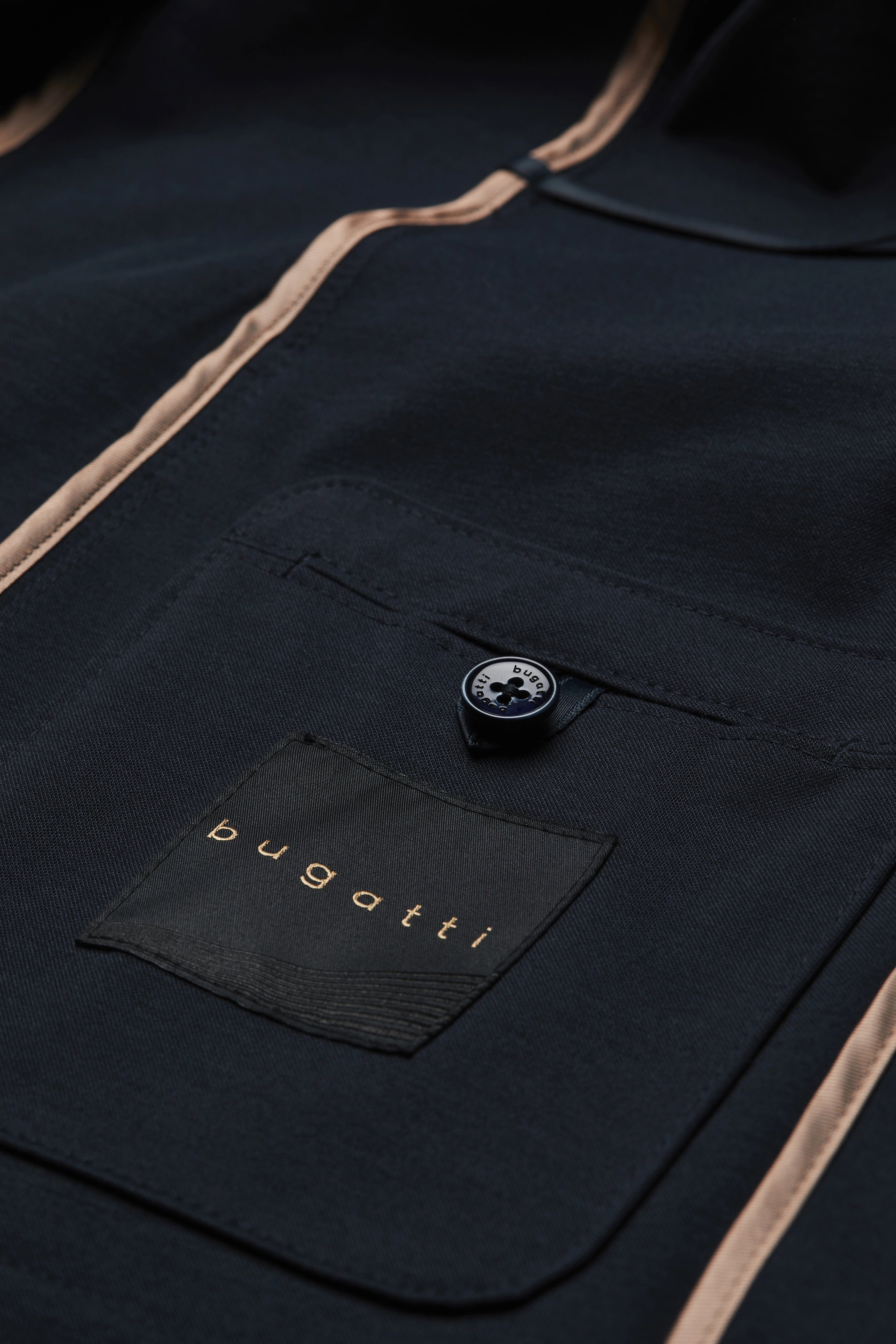 bugatti black blazer, close-up, button detail, classic elegance, high-quality craftsmanship.
