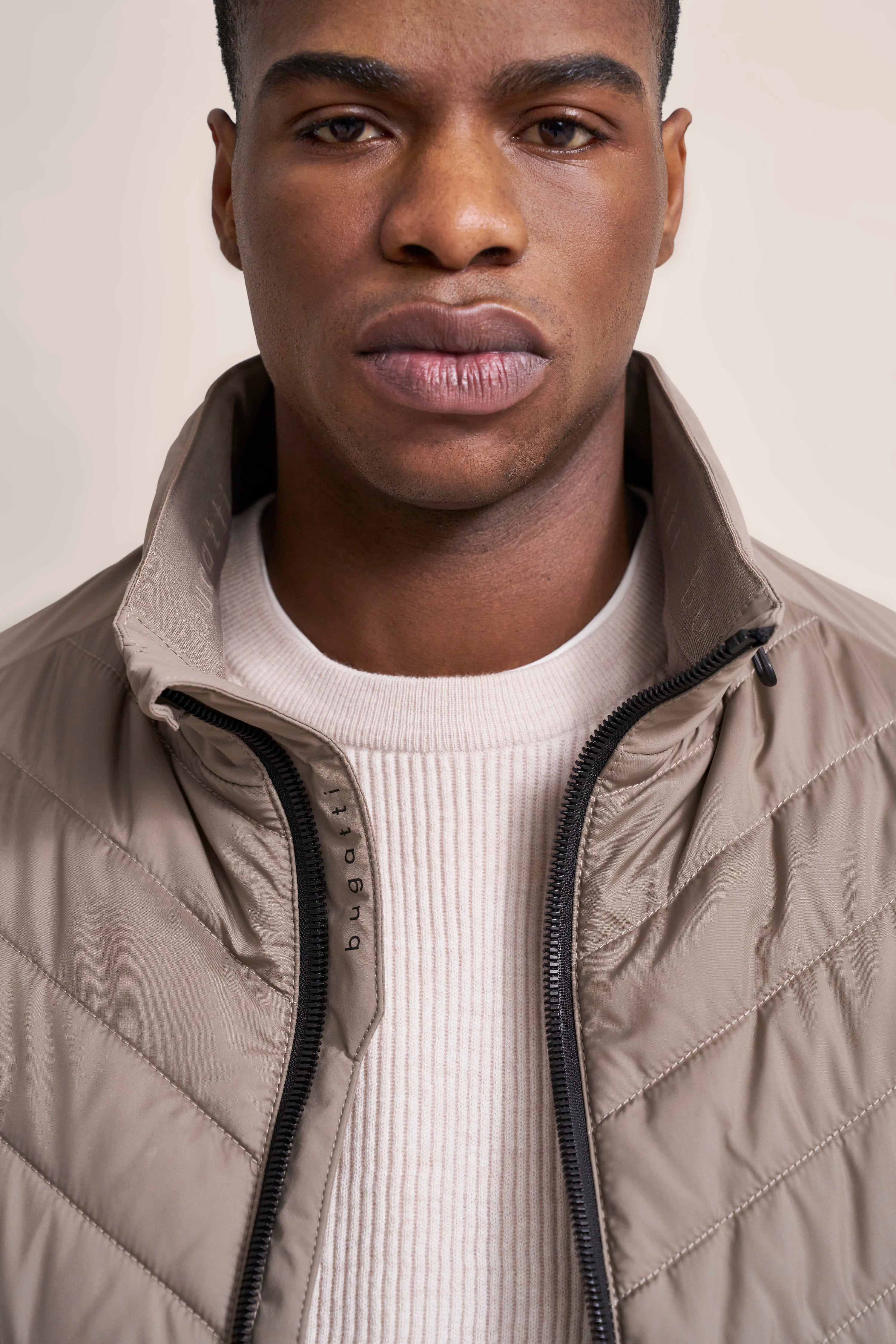 Bust shot with beige bugatti jacket and cream sweater.