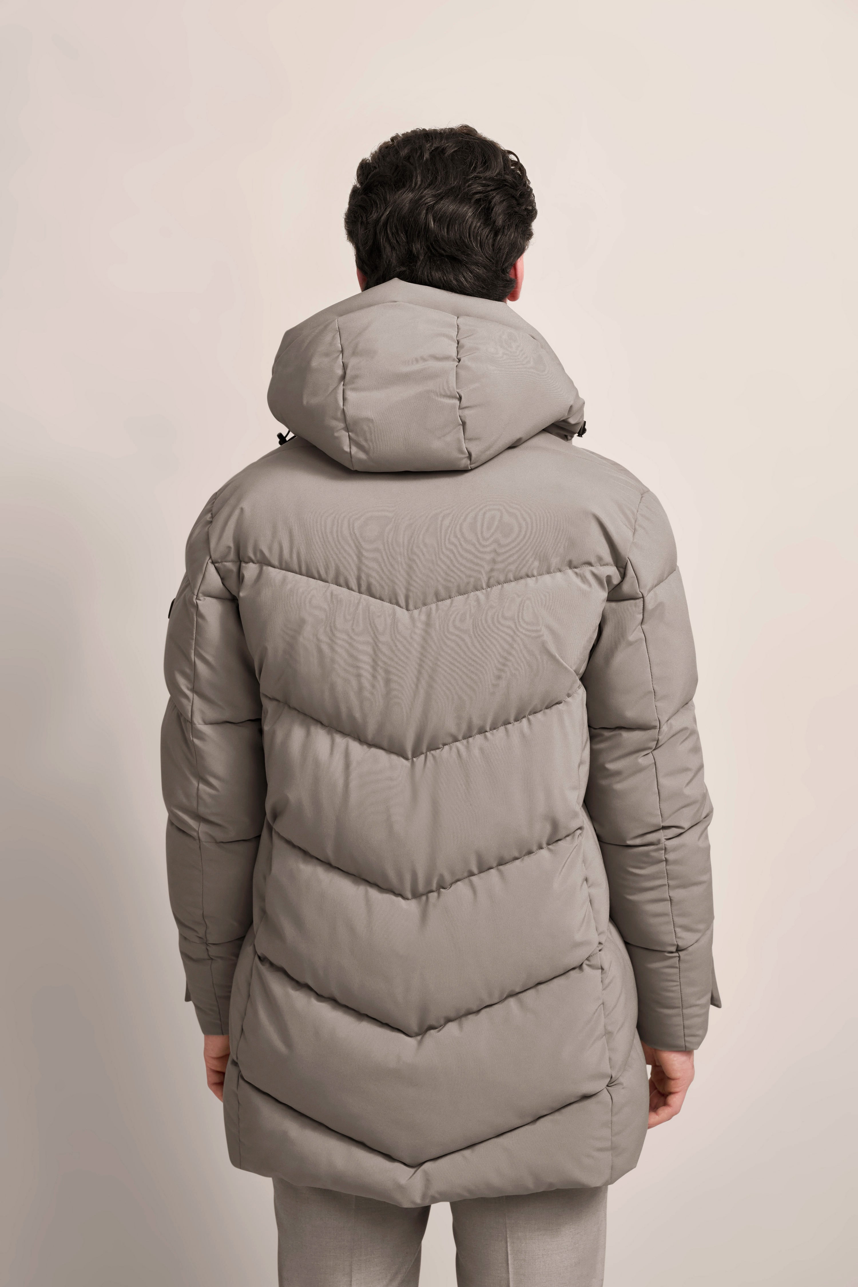 Gray bugatti down coat, back view, model pose, relaxed, stylish, and timeless.