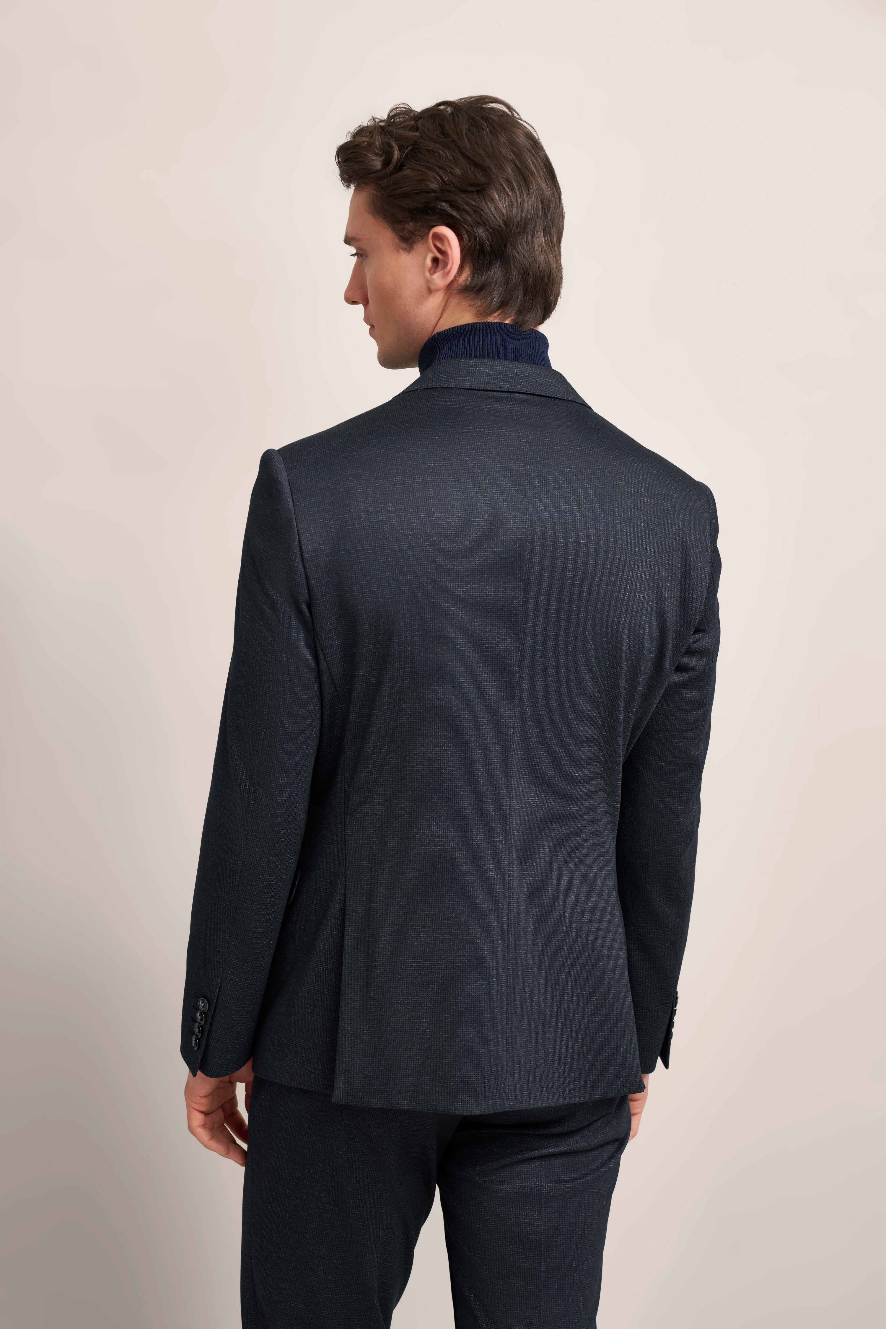 bugatti dark blue suit, back view, elegant cut, model in relaxed pose.