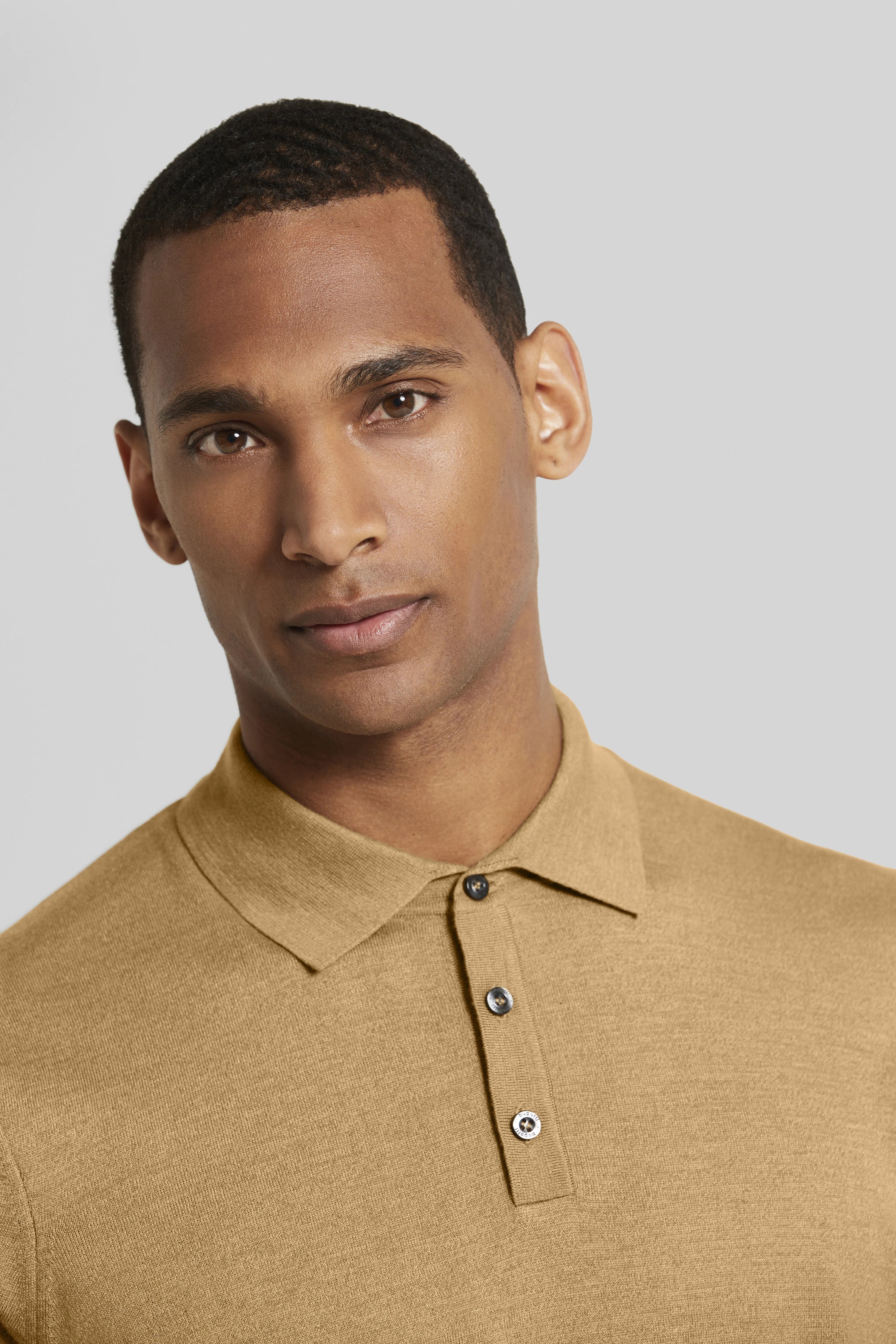 bugatti model: beige polo, classic elegance, close-up pose, timeless sophistication.