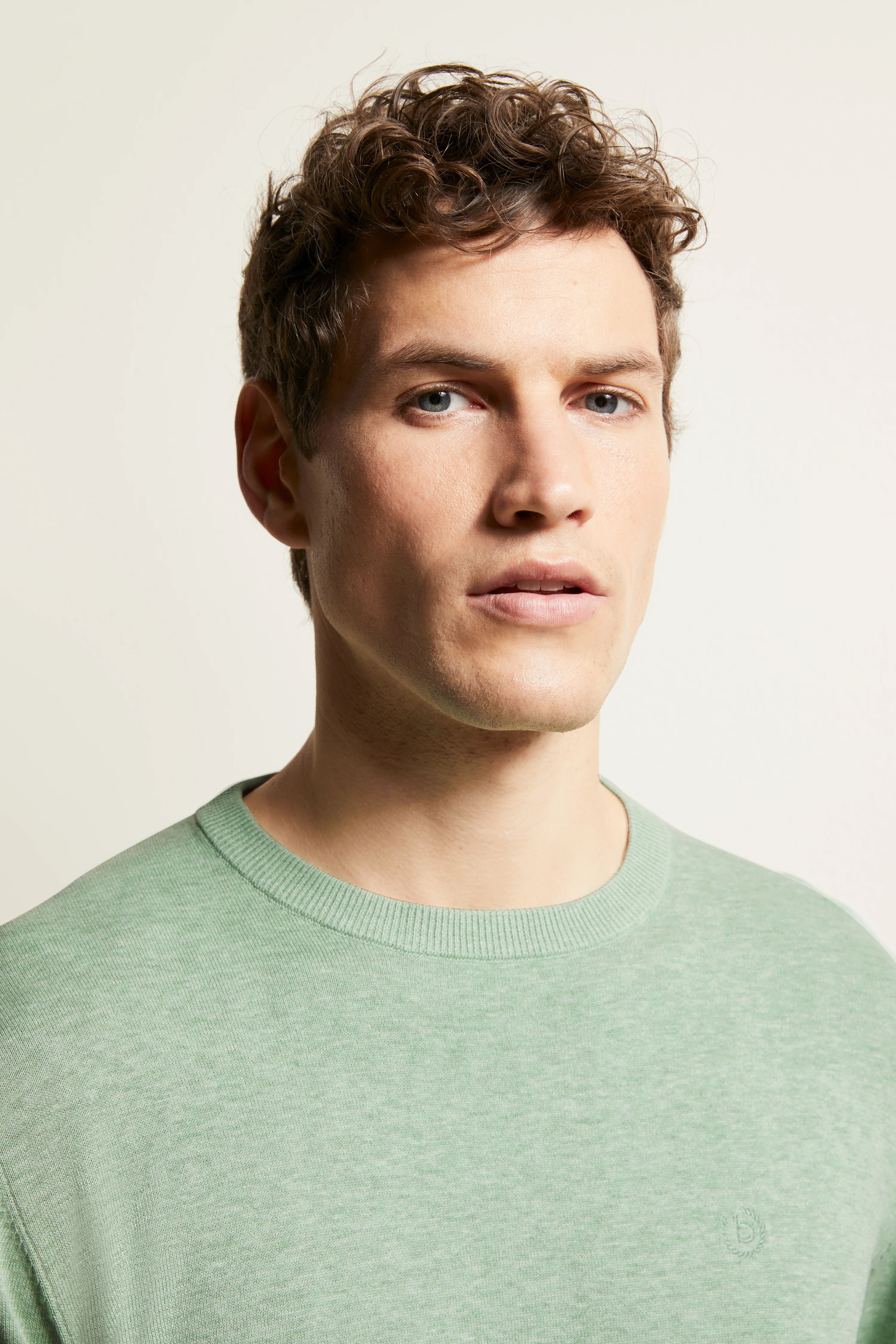 bugatti mint green sweater on model, bust shot, relaxed pose, high-quality materials.