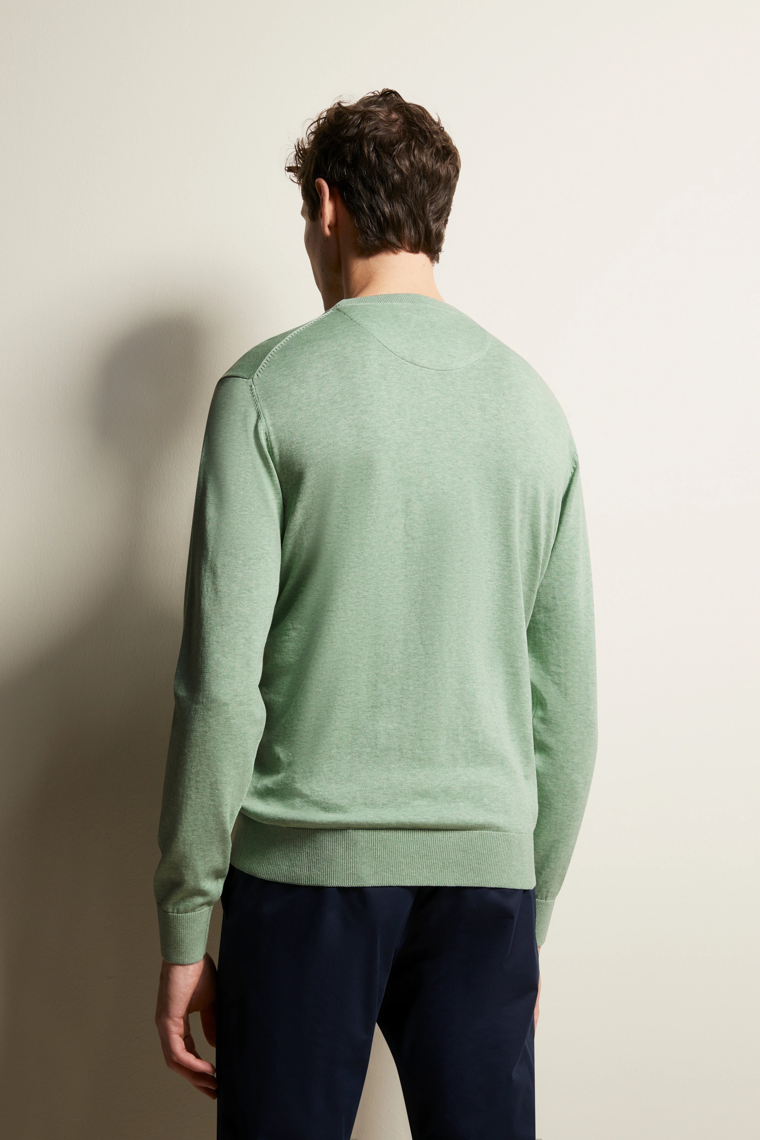 Green bugatti sweater, back view, casual model shot.