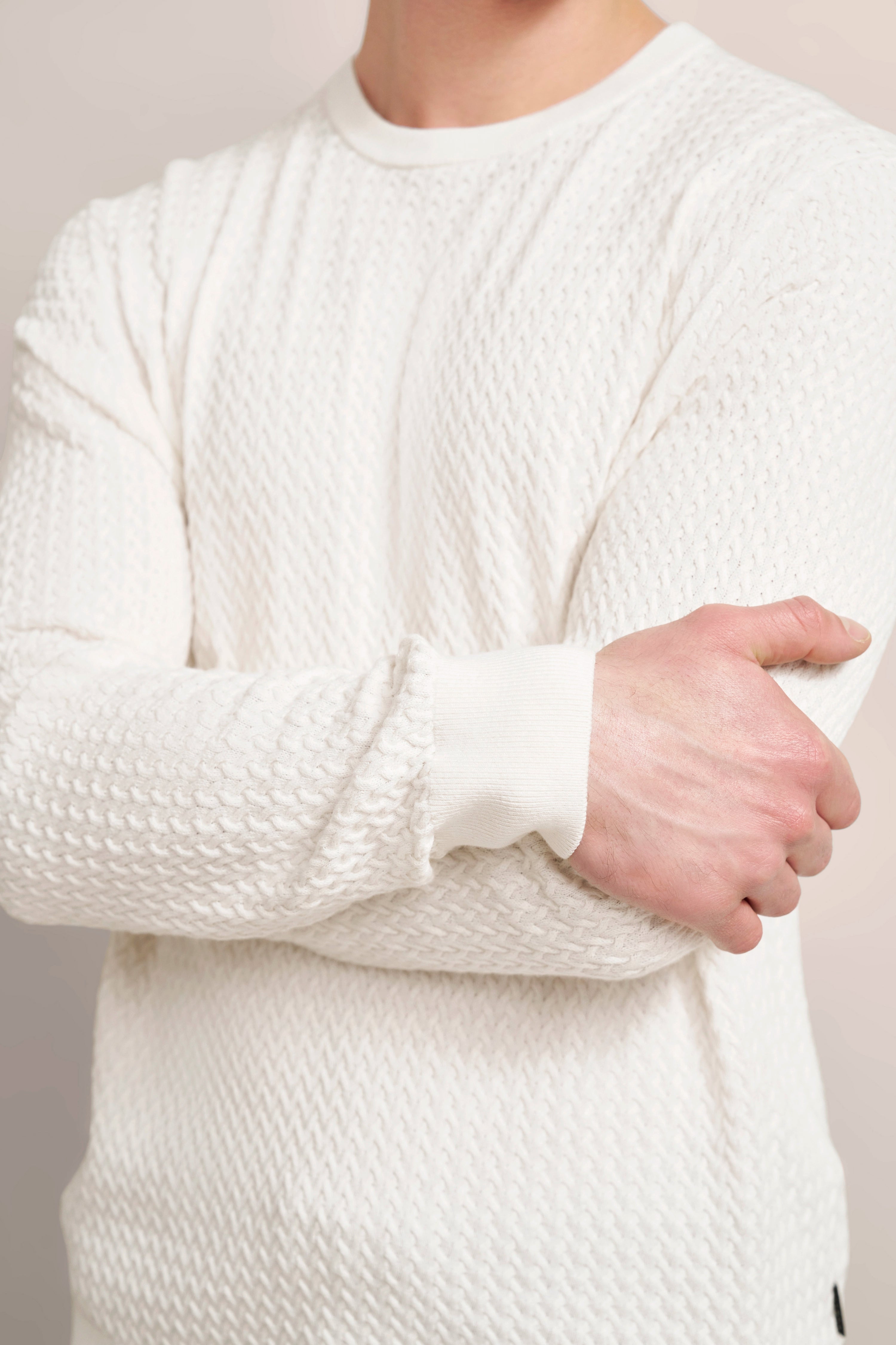 White bugatti knit sweater, bust view, relaxed pose, premium texture.