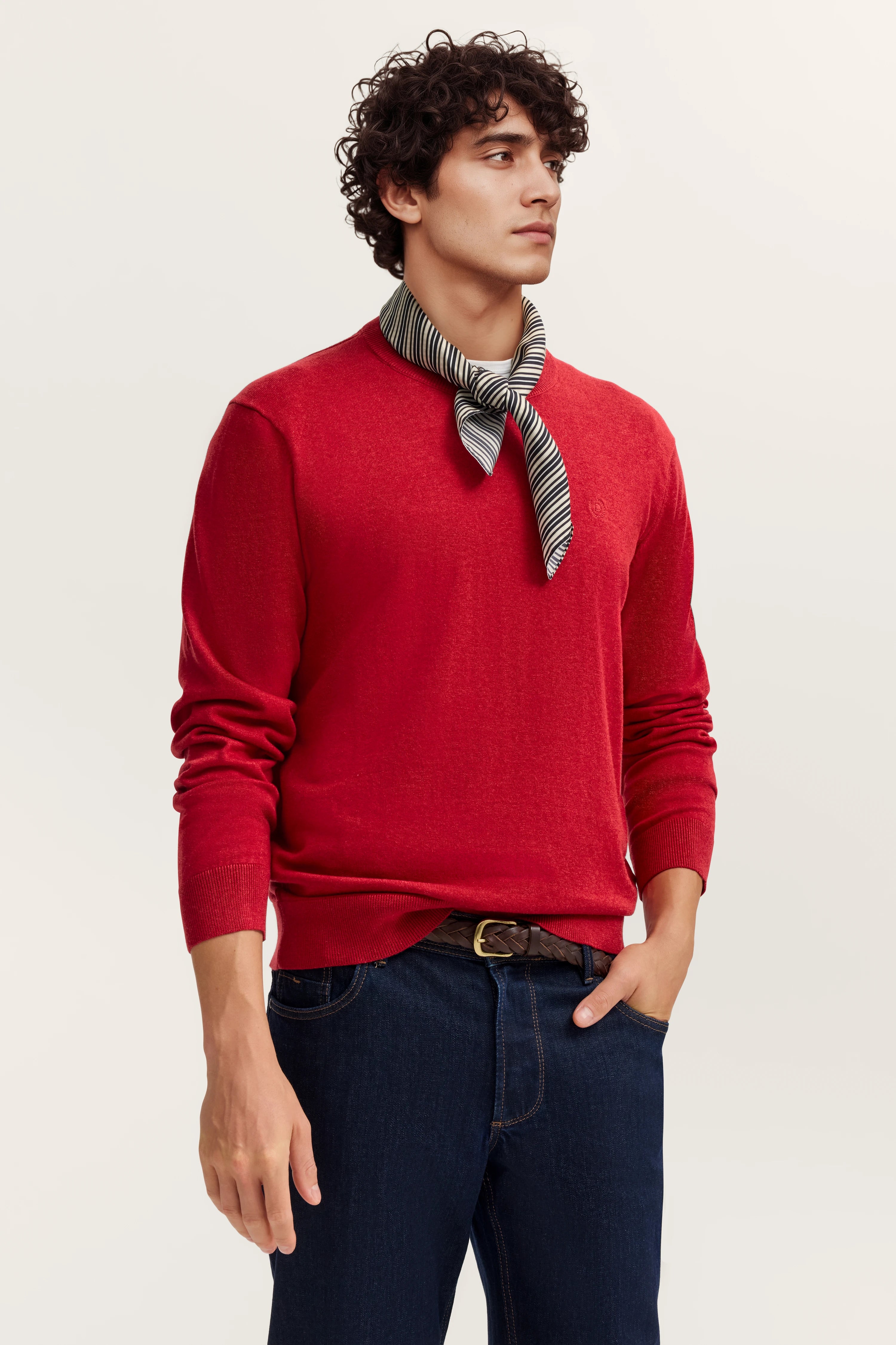 Roter Pullover, gestreiftes Halstuch, dunkle Jeans