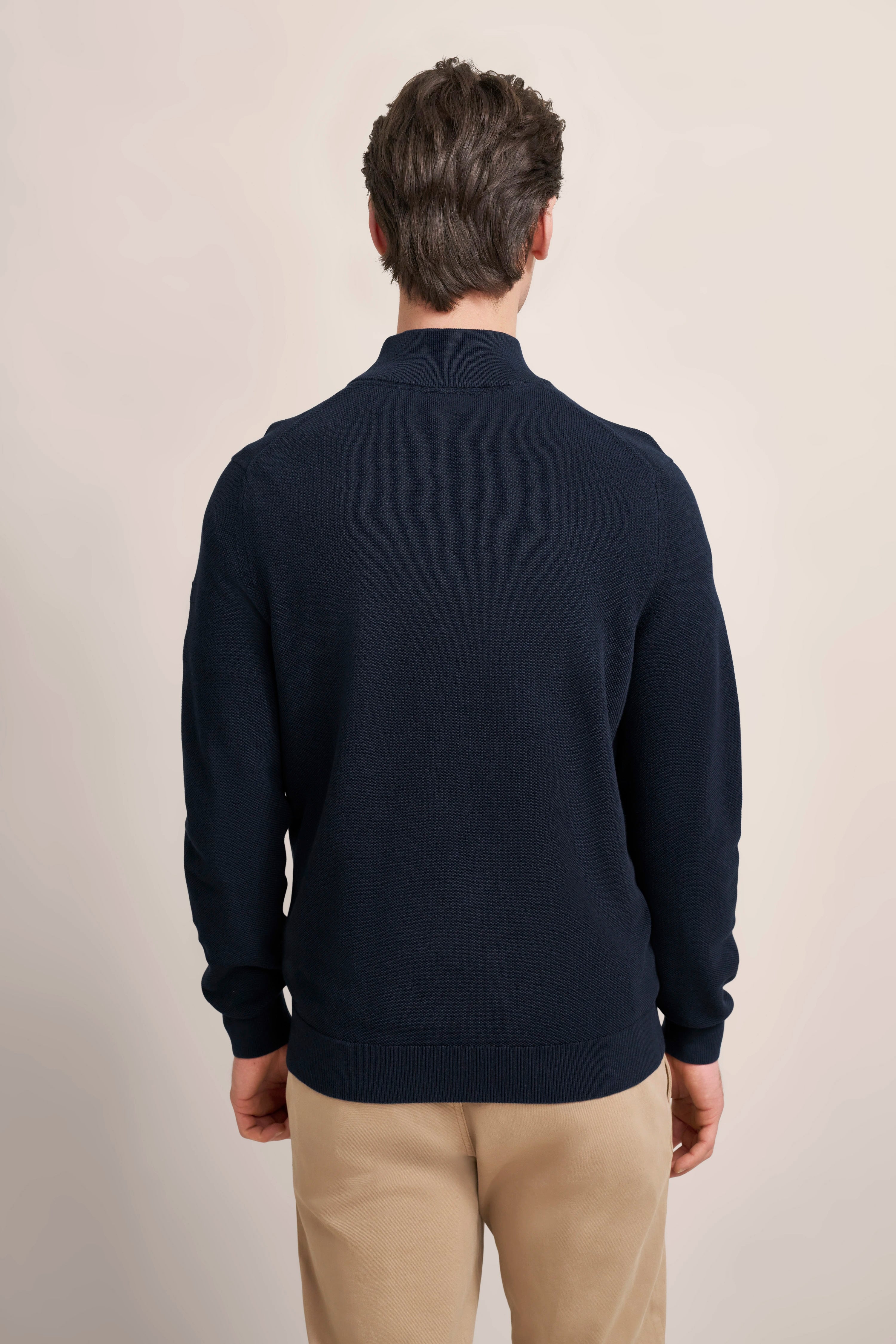 Navy pullover, beige chinos, model from back, casual portrait, bugatti style.