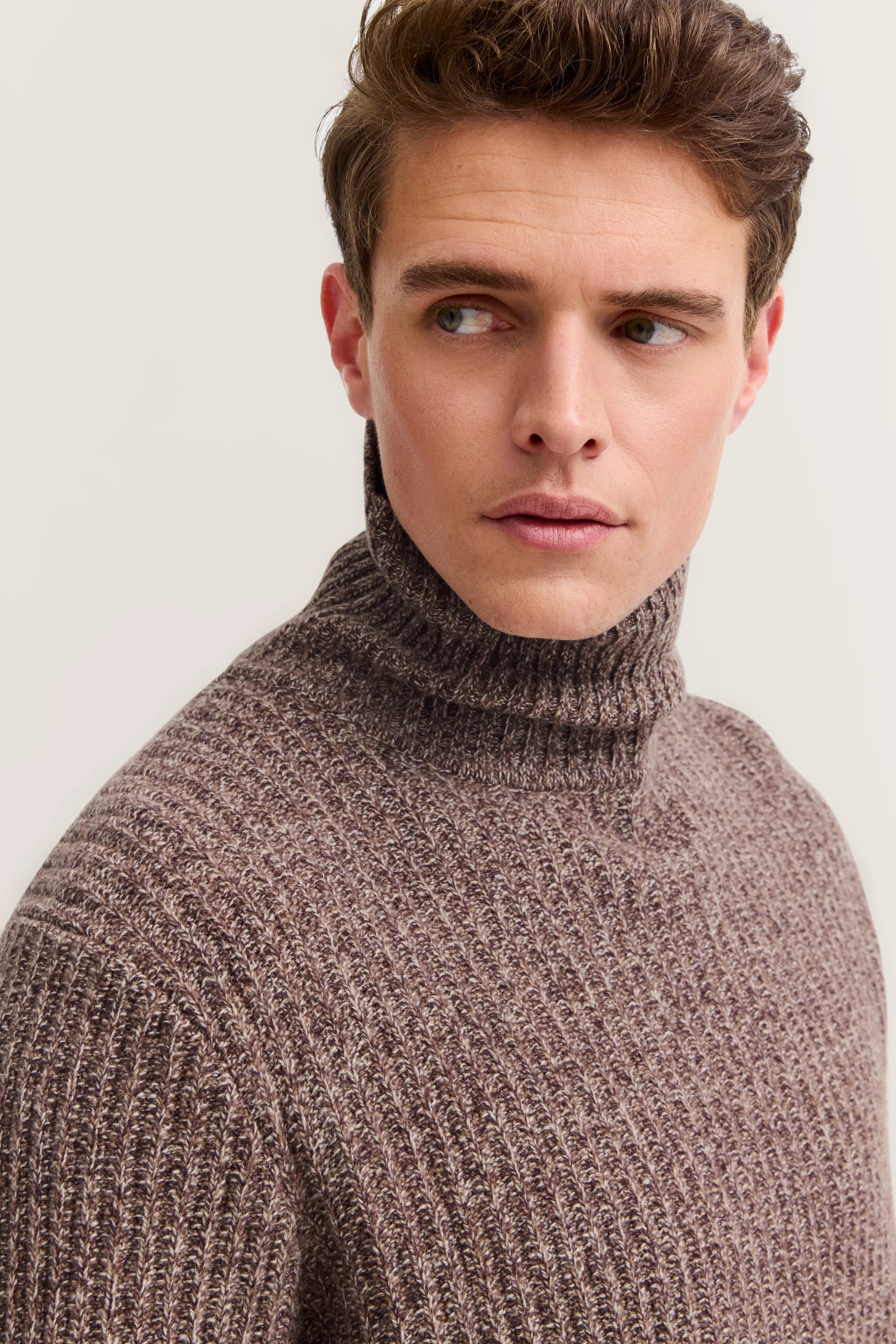 Bust shot of brown chunky knit turtleneck sweater by bugatti.