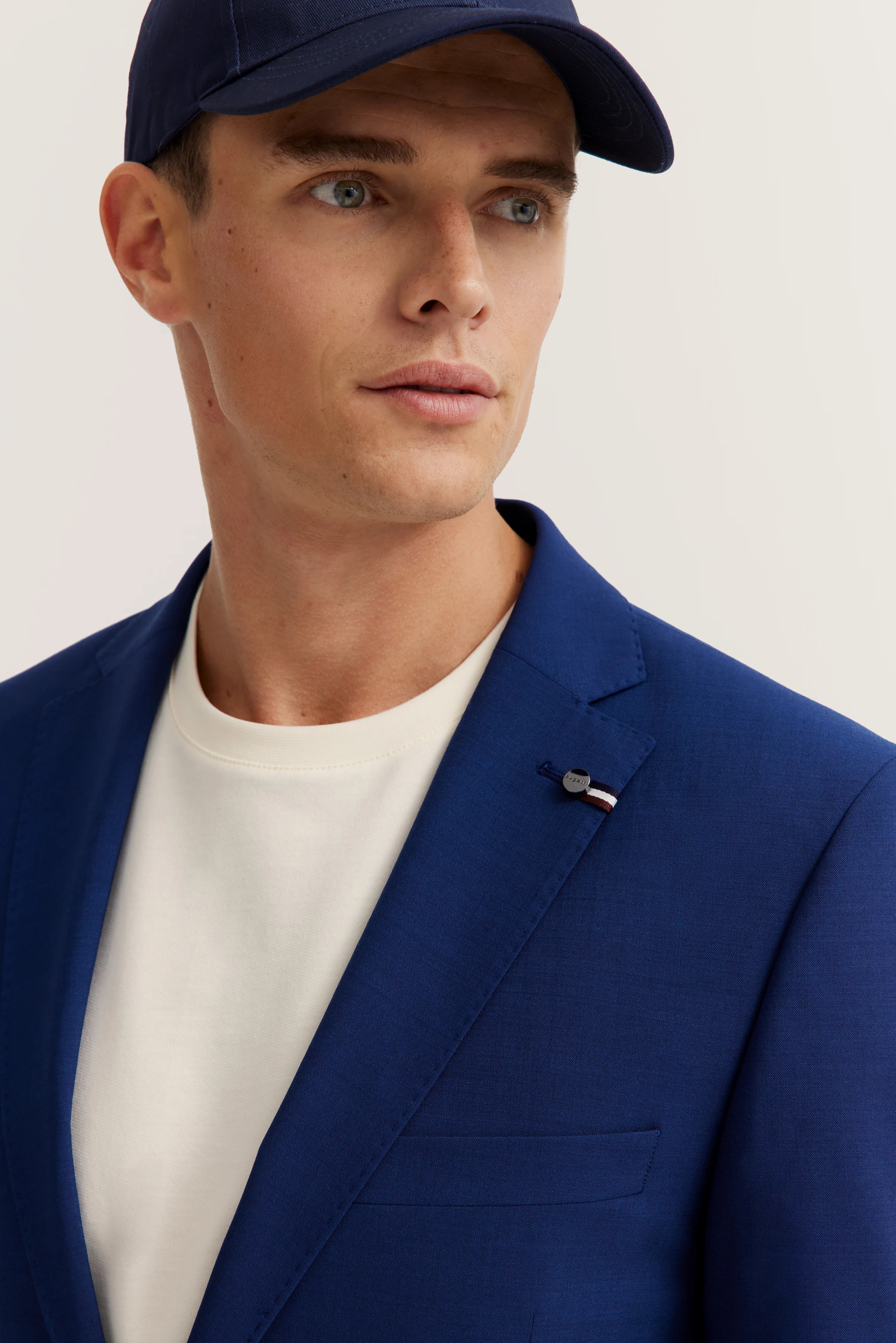 Model in blue bugatti blazer and white T-shirt, casual pose.