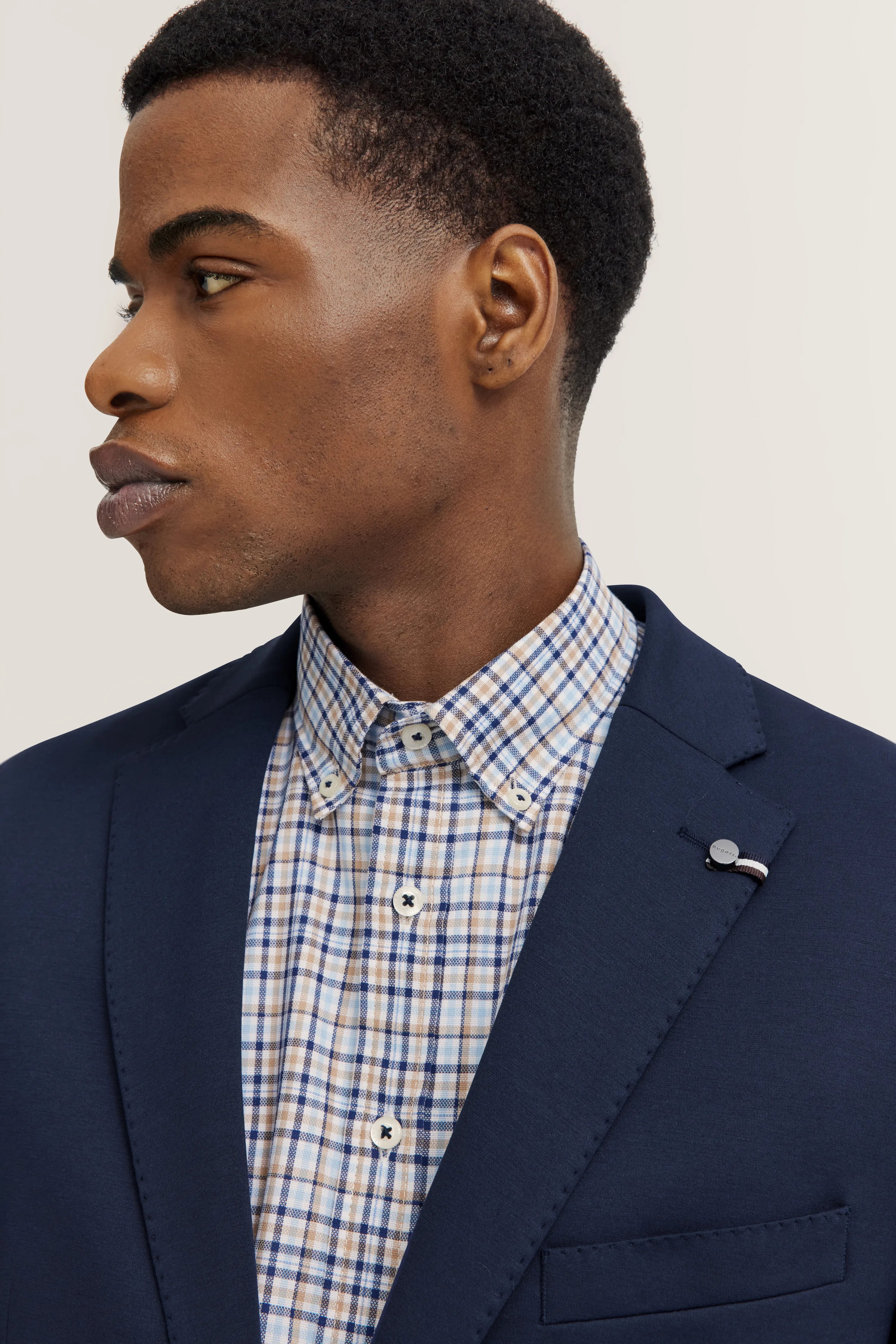 Blue blazer with checkered beige and blue shirt on bust, bugatti style and elegance.