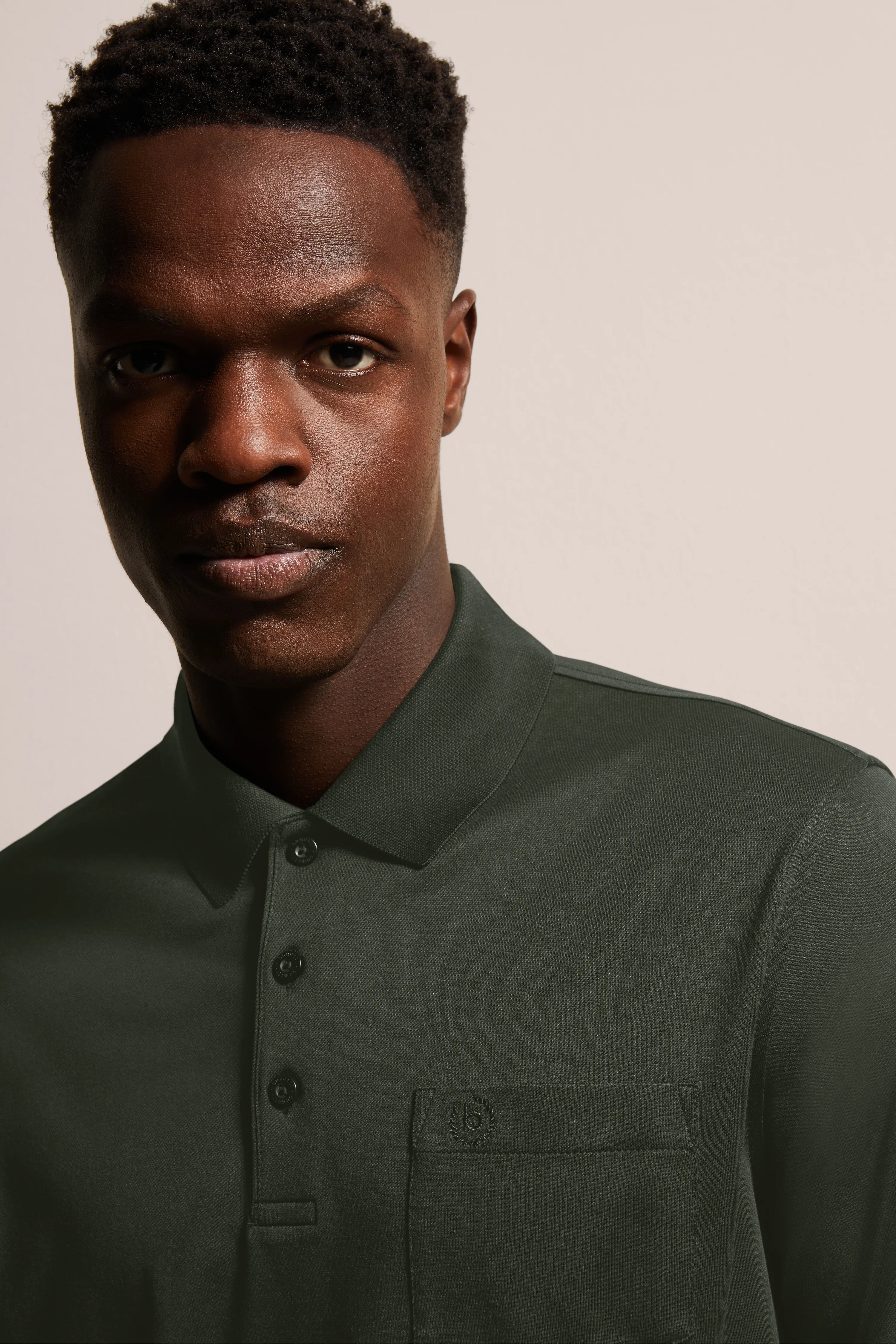 Green polo shirt by bugatti, model image, relaxed expression.