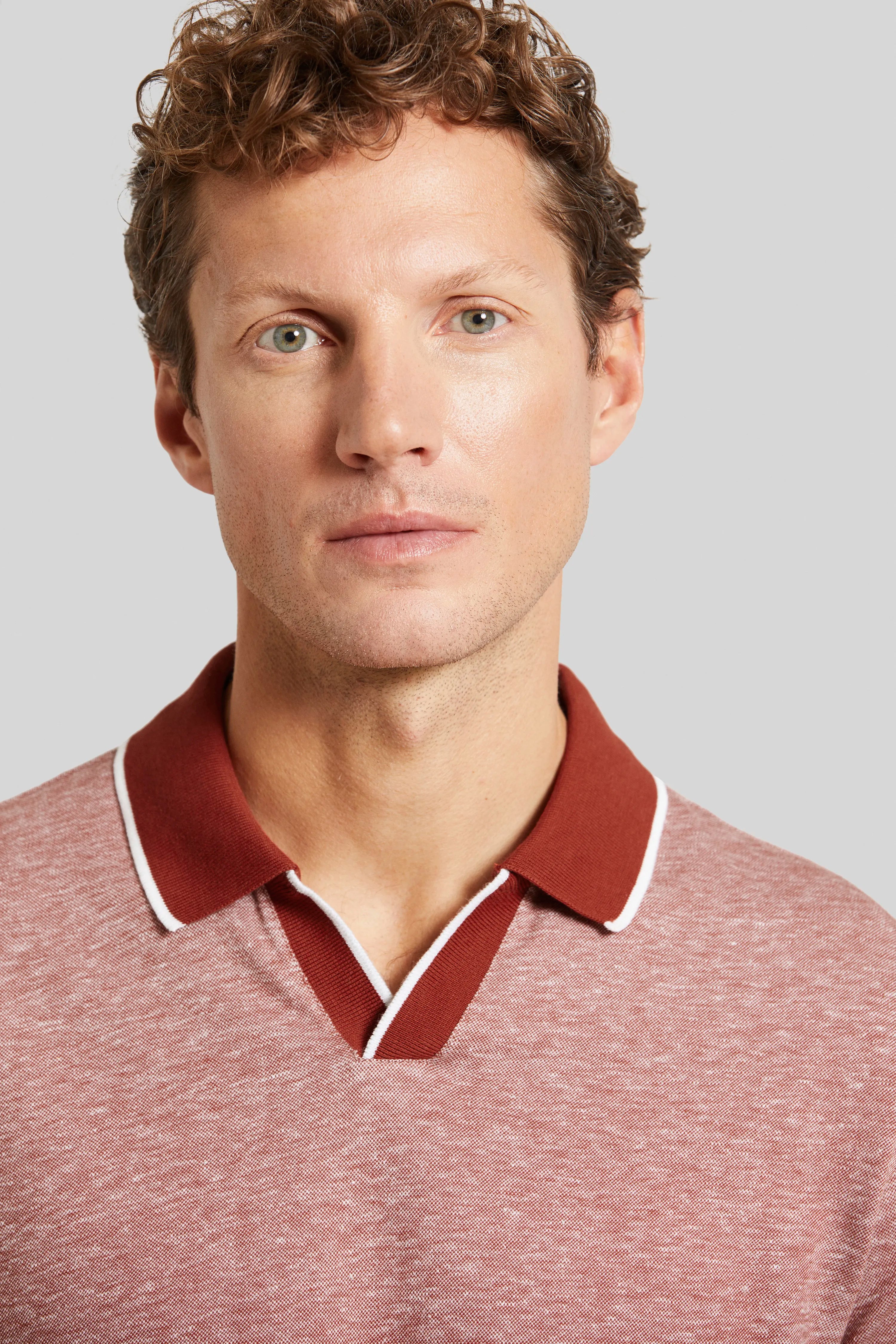 Bugatti Modell in rot-weißem Poloshirt, legeres Büstenbild.