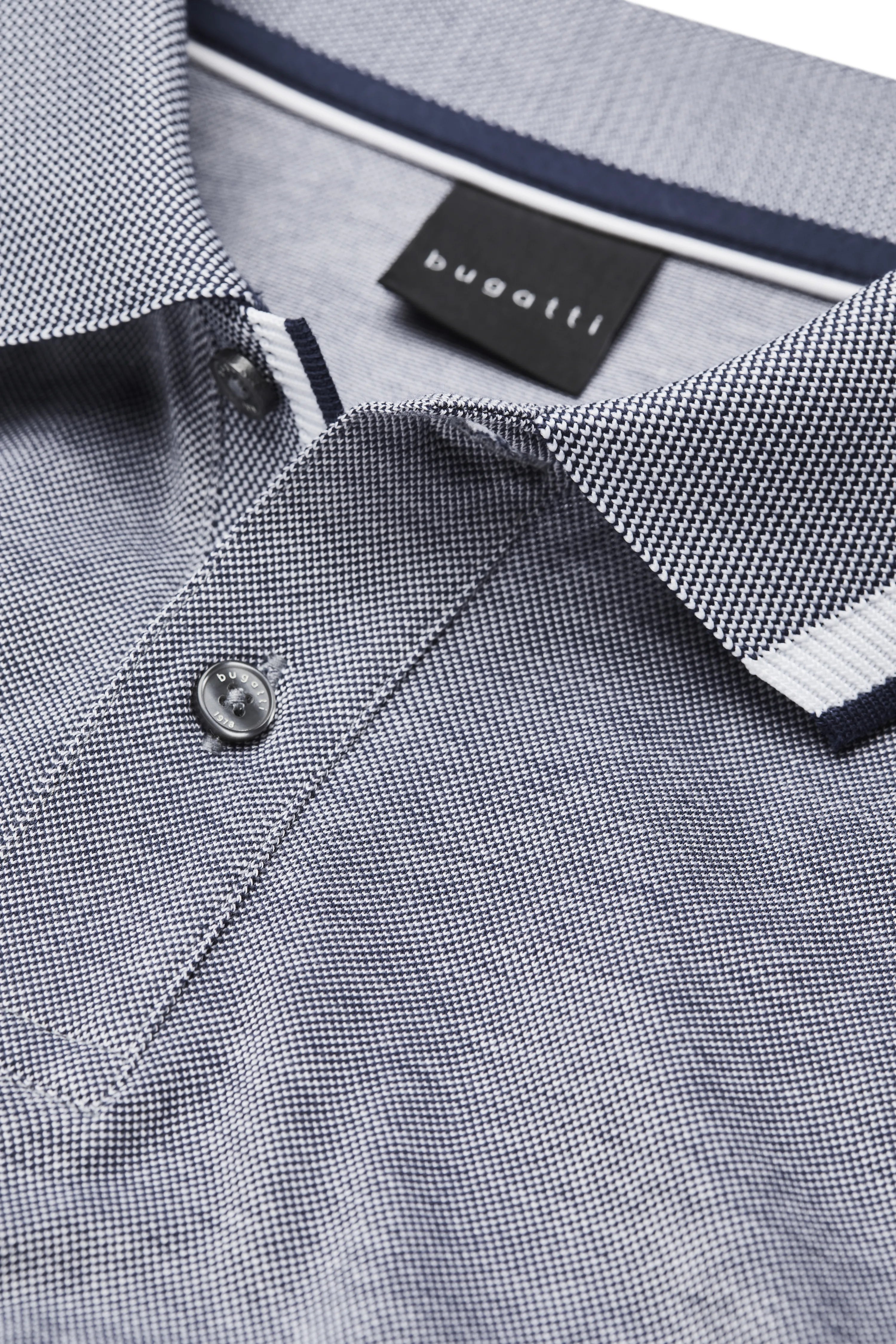 bugatti polo shirt in melange grey, white collar edge, model in relaxed pose.