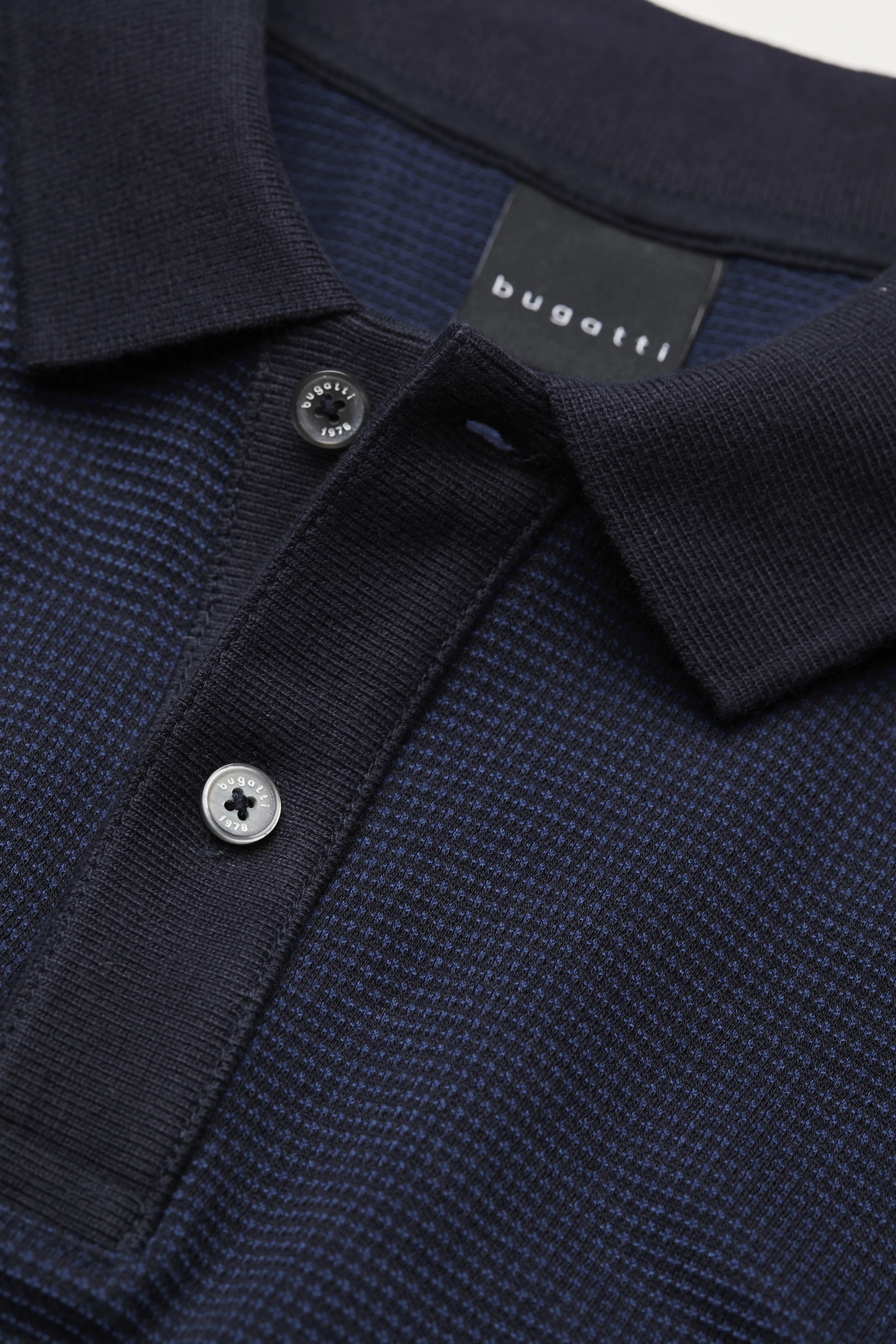 Dark blue bugatti polo shirt, close-up, subtle texture, button placket with label.