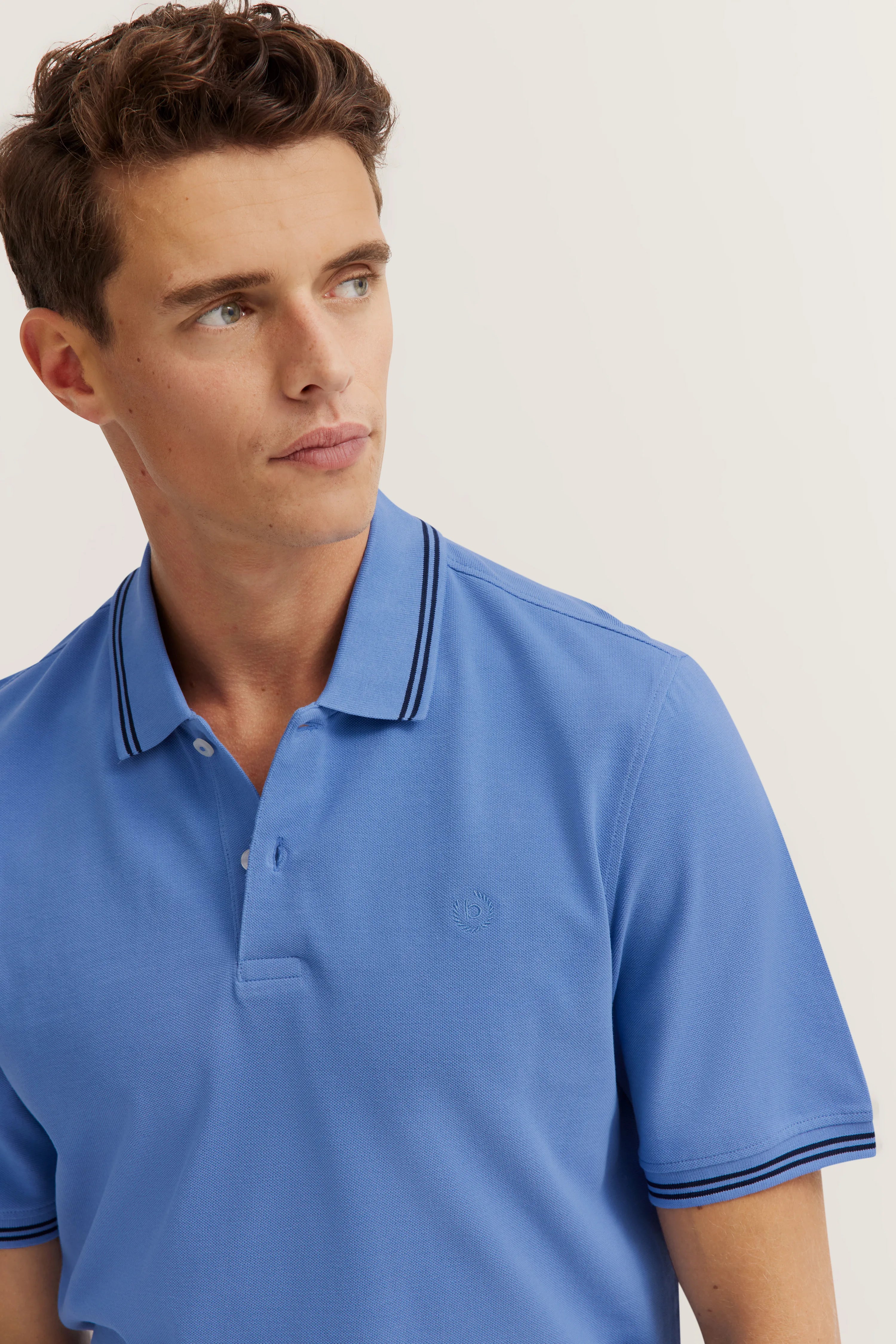 Blue bugatti polo shirt worn by model, casual look.