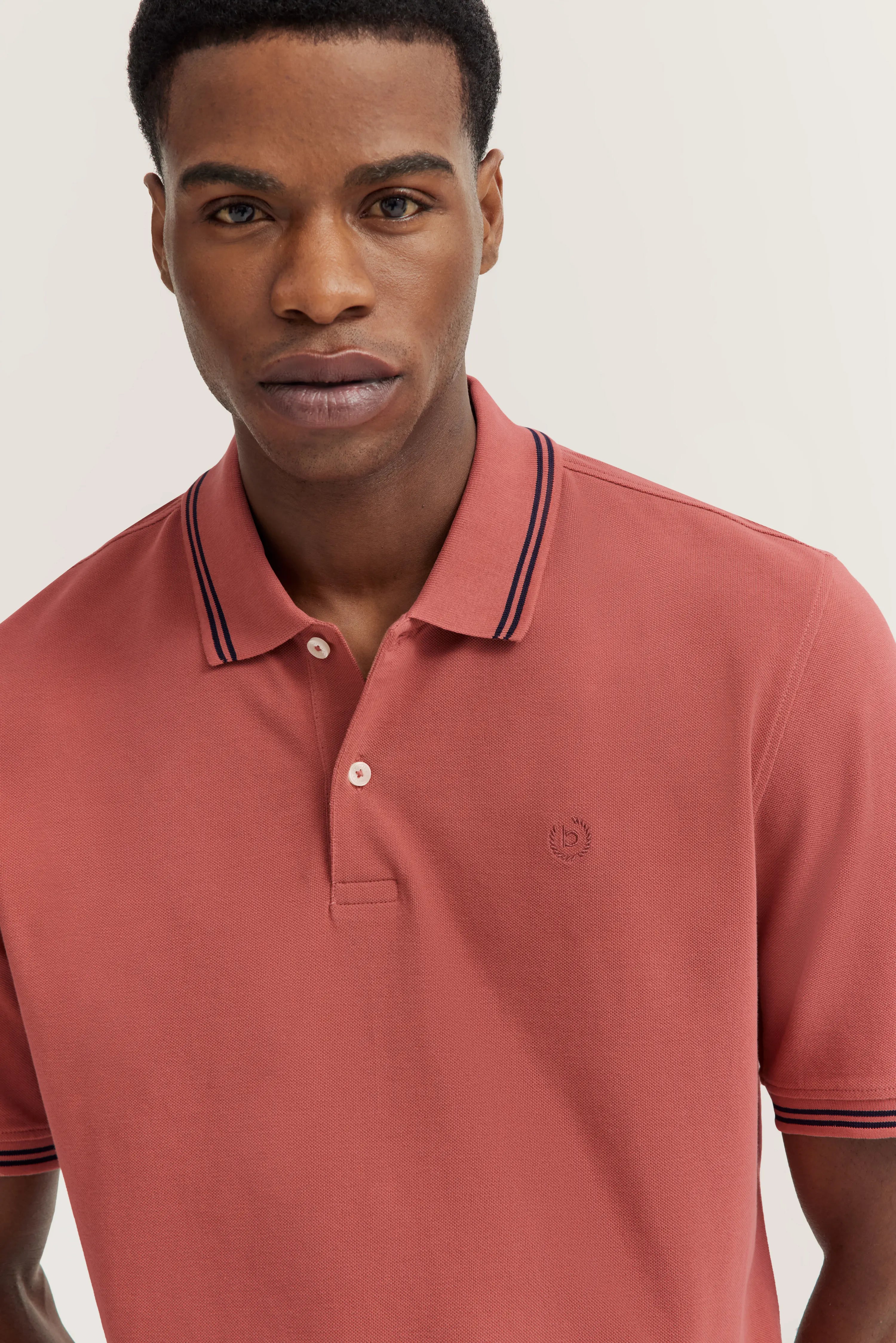 bugatti coral polo with contrast stripes, bust view.