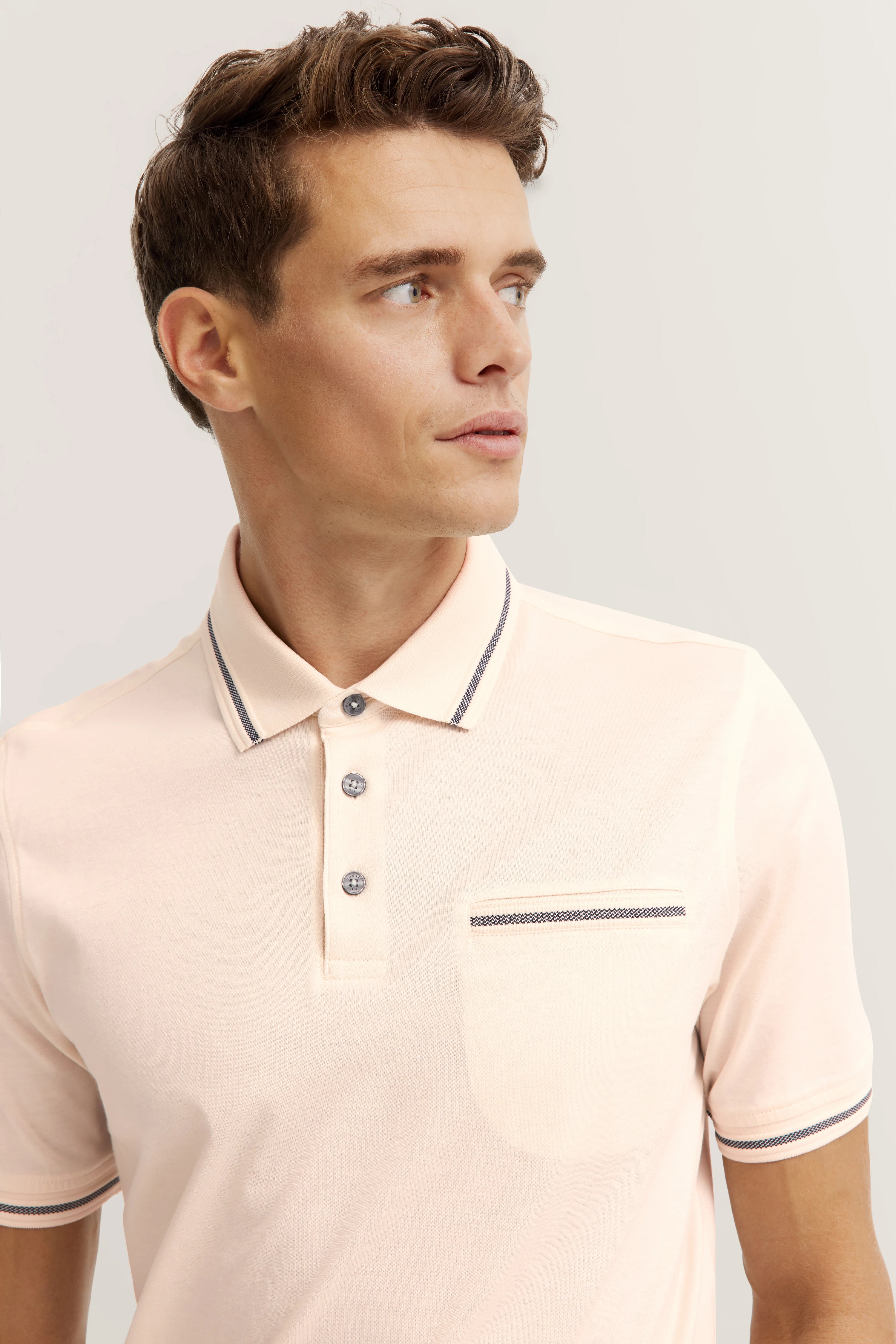bugatti polo shirt in cream with stripe details, model image, side view.