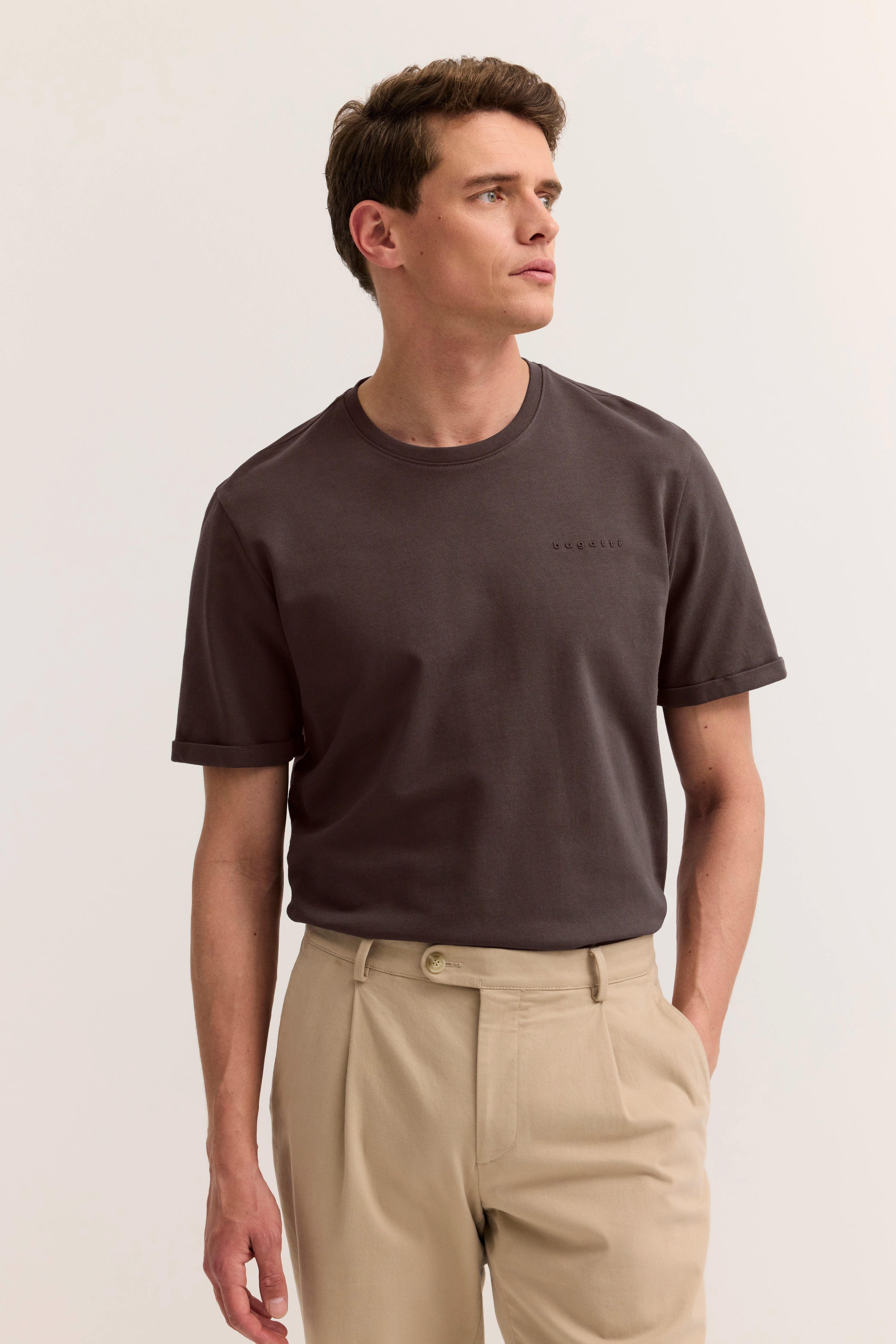 Model trägt braunes bugatti T-Shirt und beige Hose
