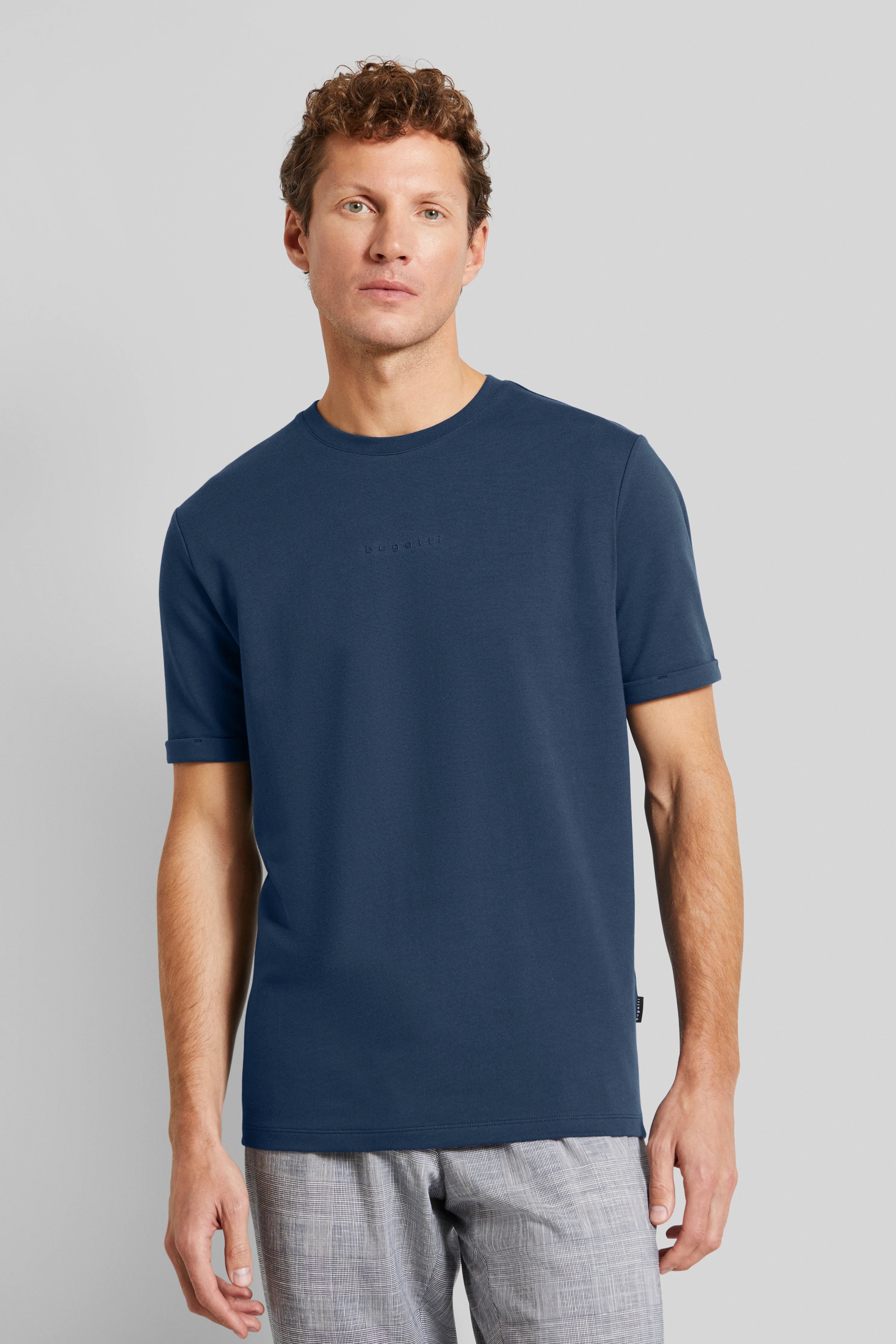 Blue bugatti T-shirt with gray patterned pants, casual model pose, relaxed vibe.