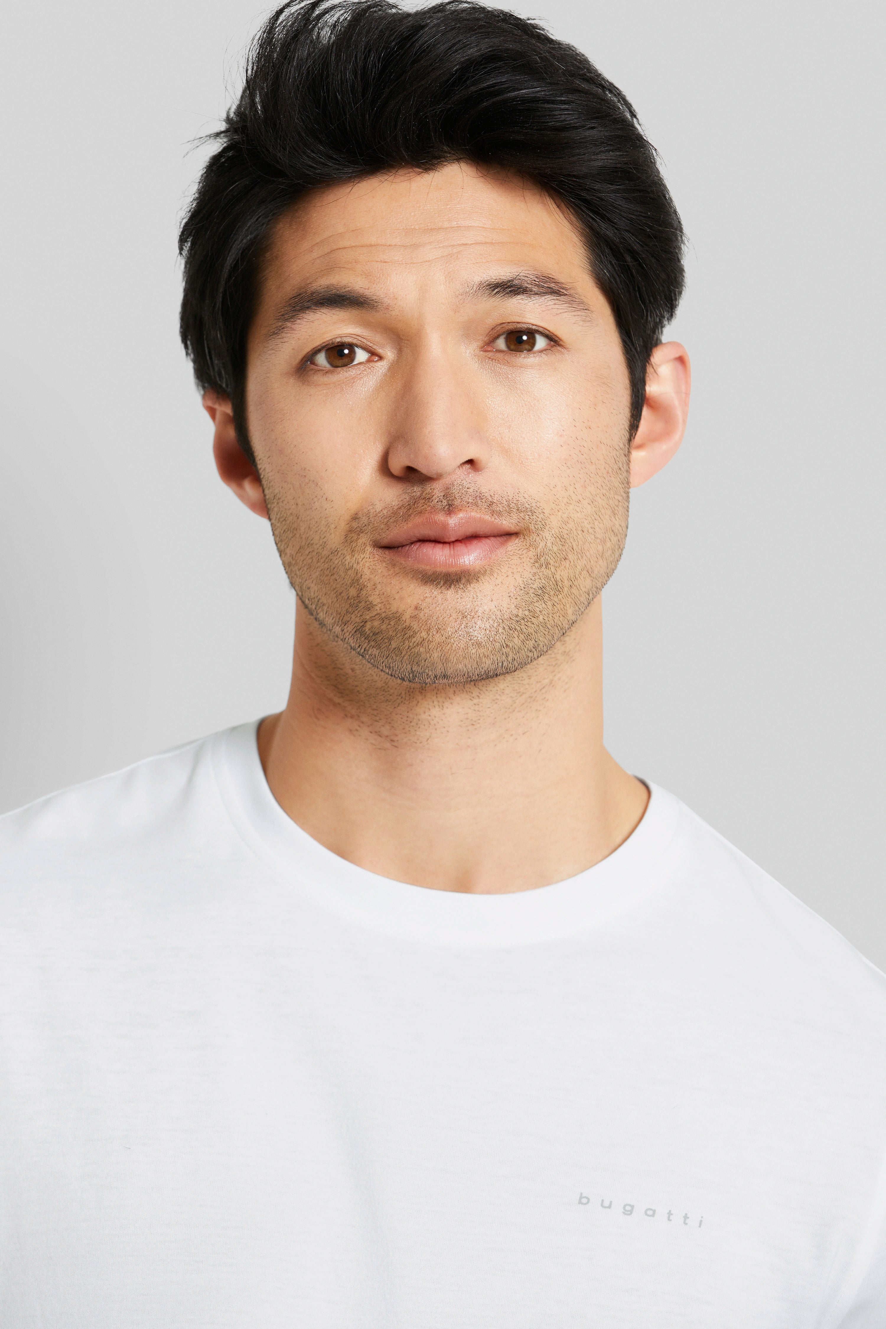 Bust of a man in a white bugatti T-shirt