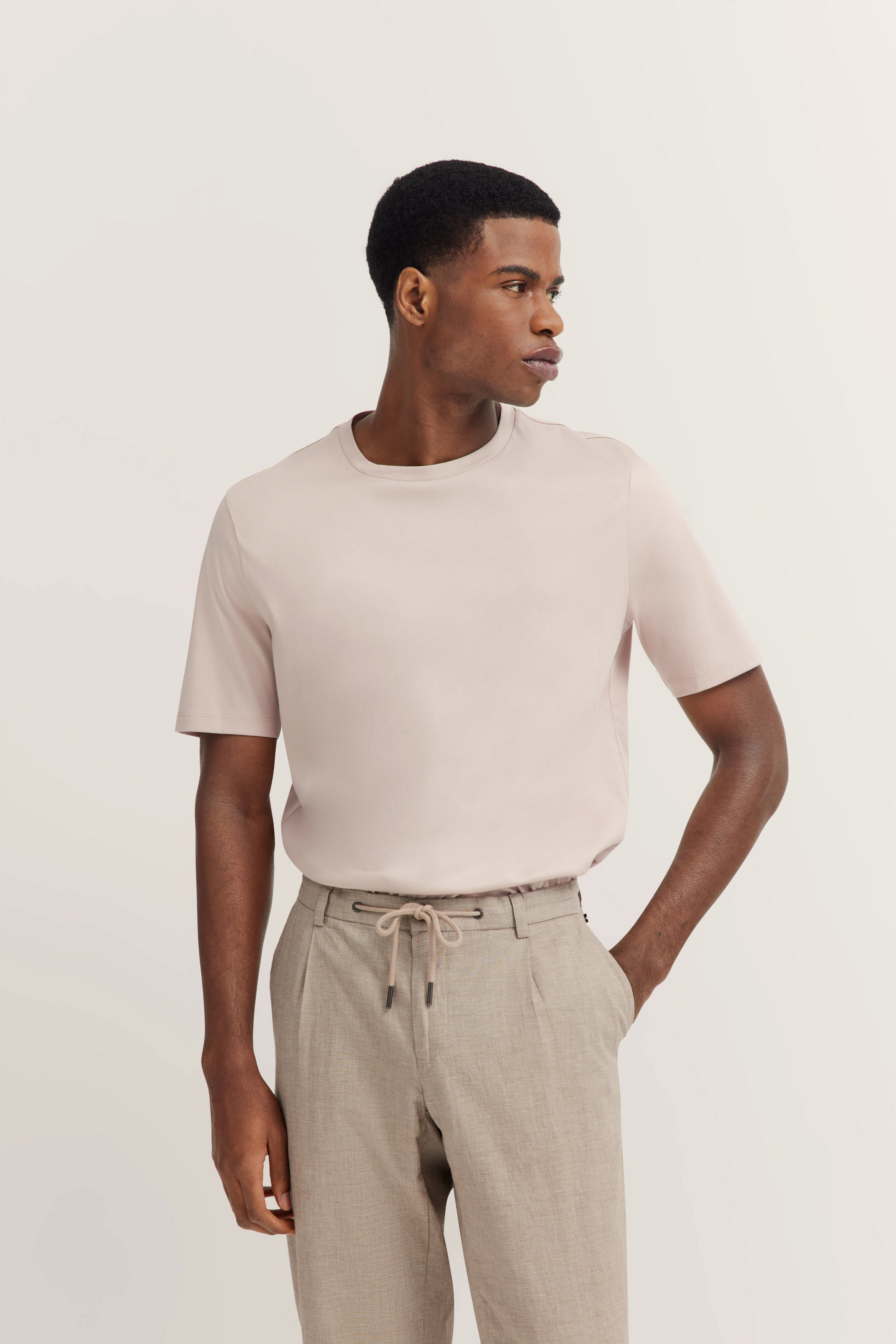 bugatti model in beige T-shirt & light brown pants, exuding Italian-inspired elegance and style.