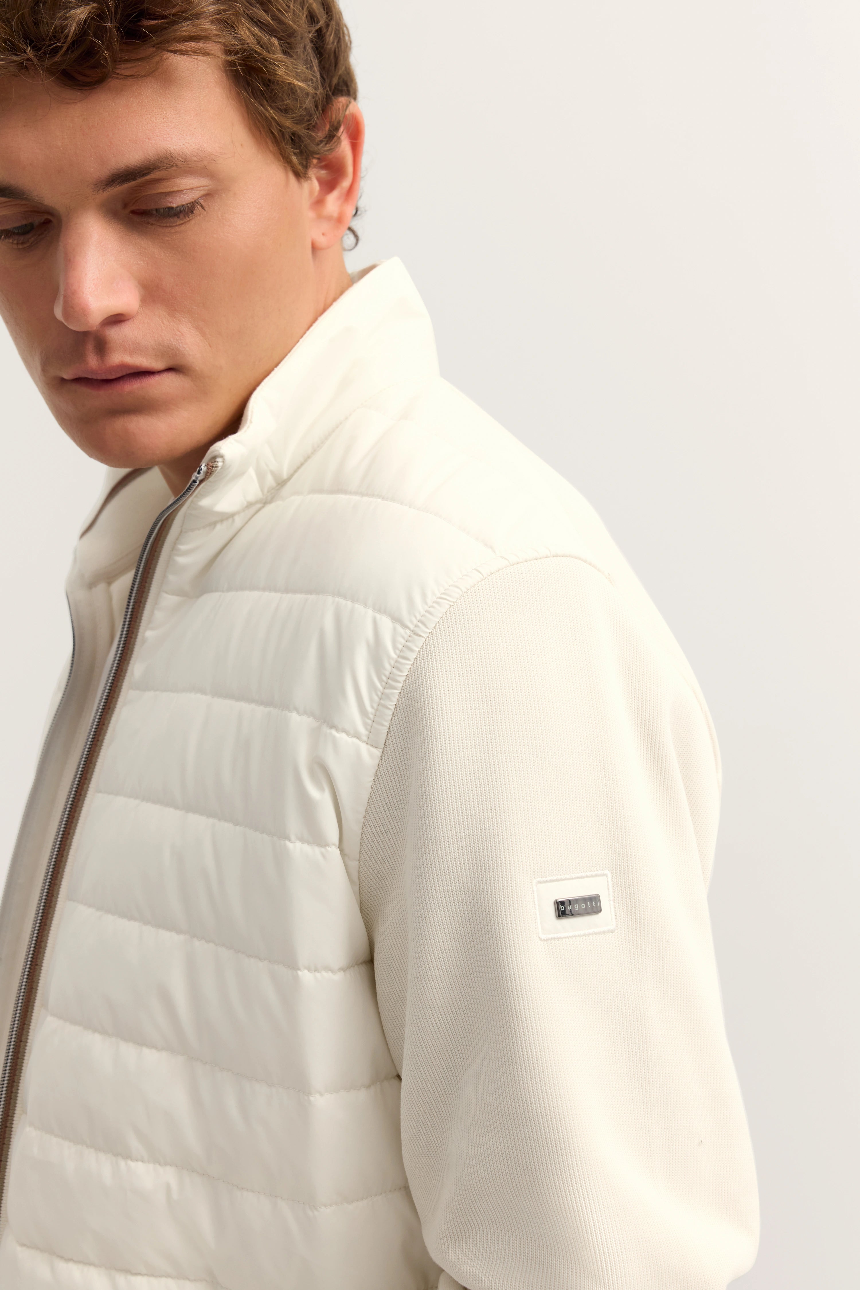 Weiße bugatti Steppjacke auf Model, entspannte Pose, Seitenansicht.