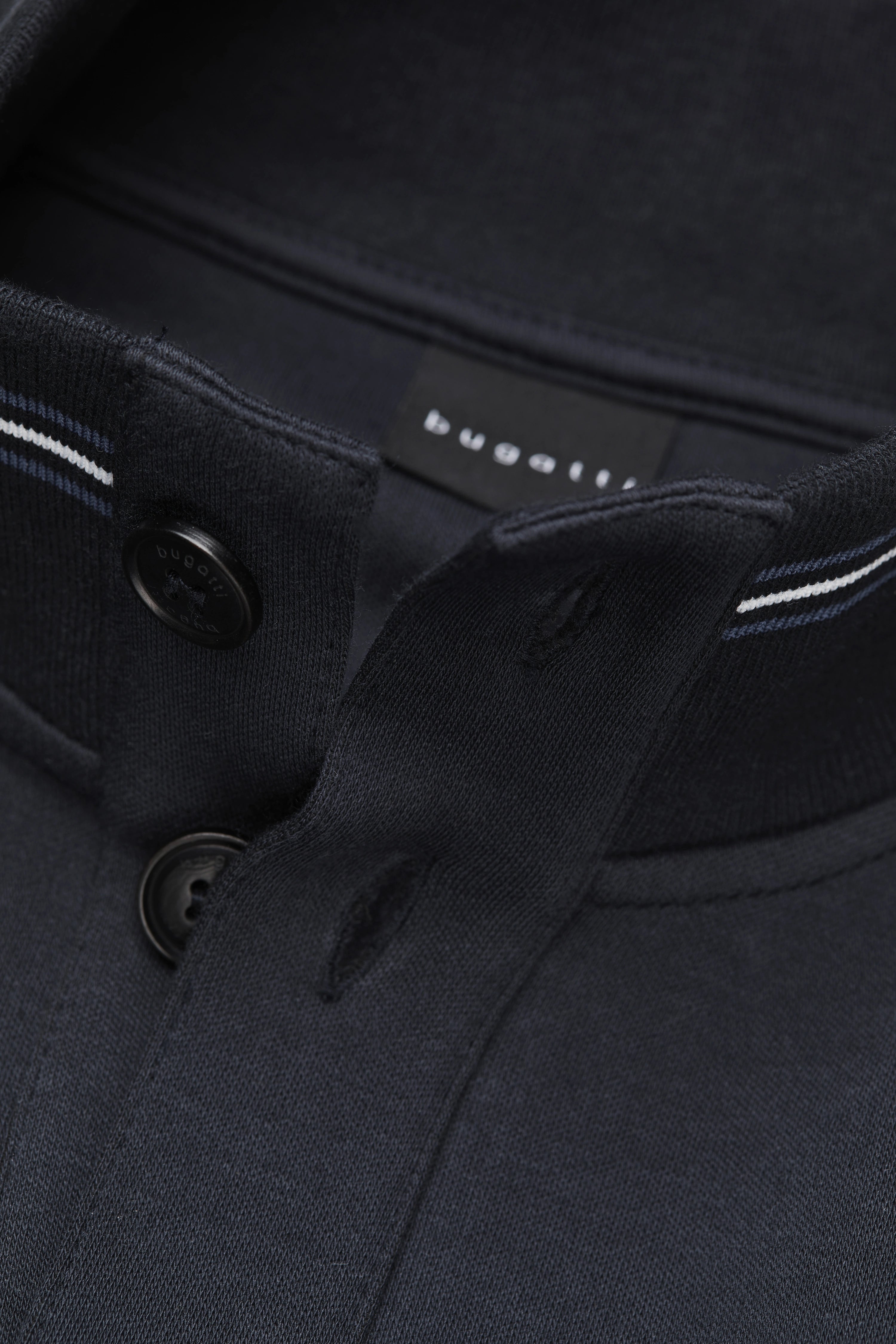 Dark blue bugatti polo shirt with button placket, detail shot, no model.