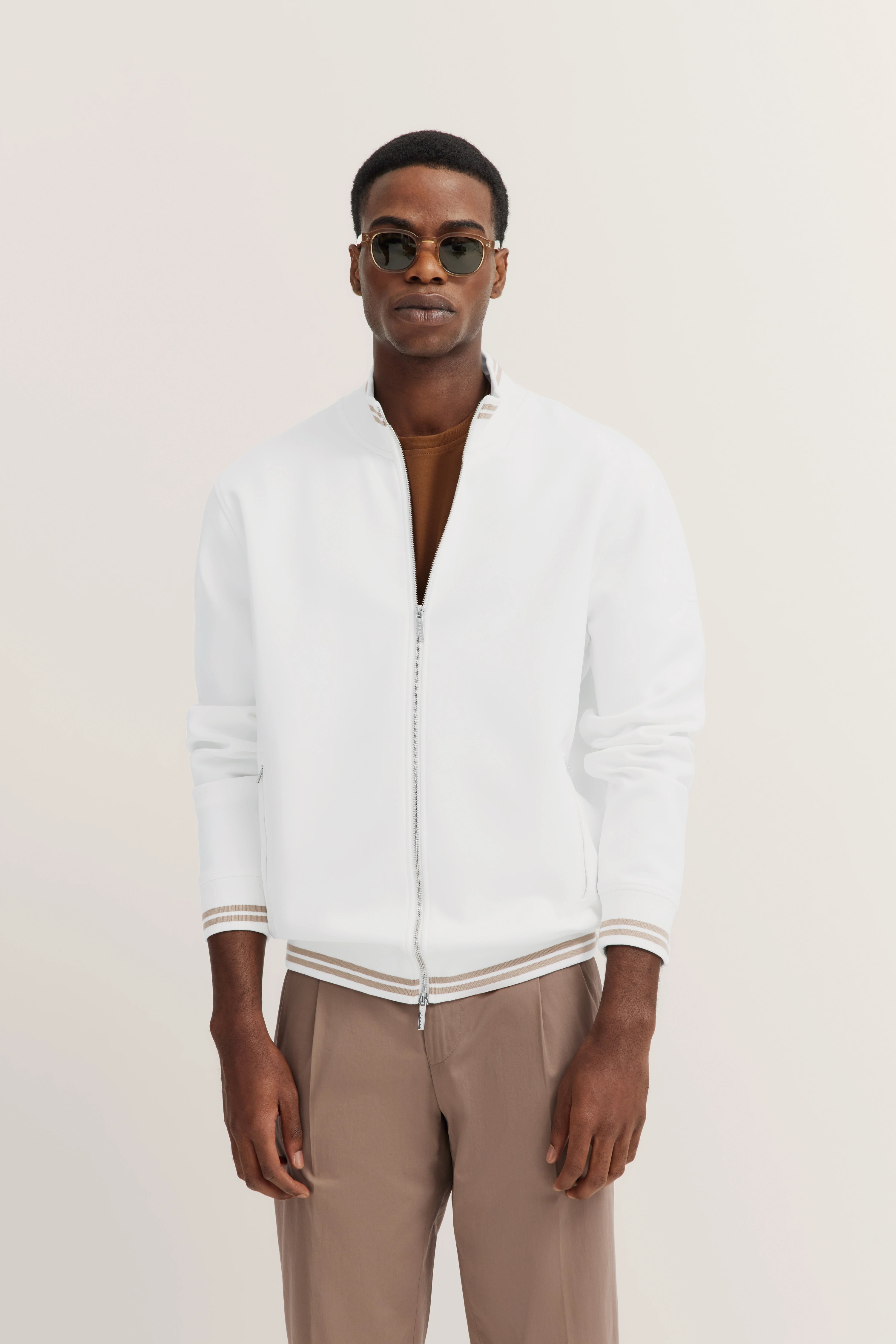 White bugatti blouson, brown shirt, beige pants
