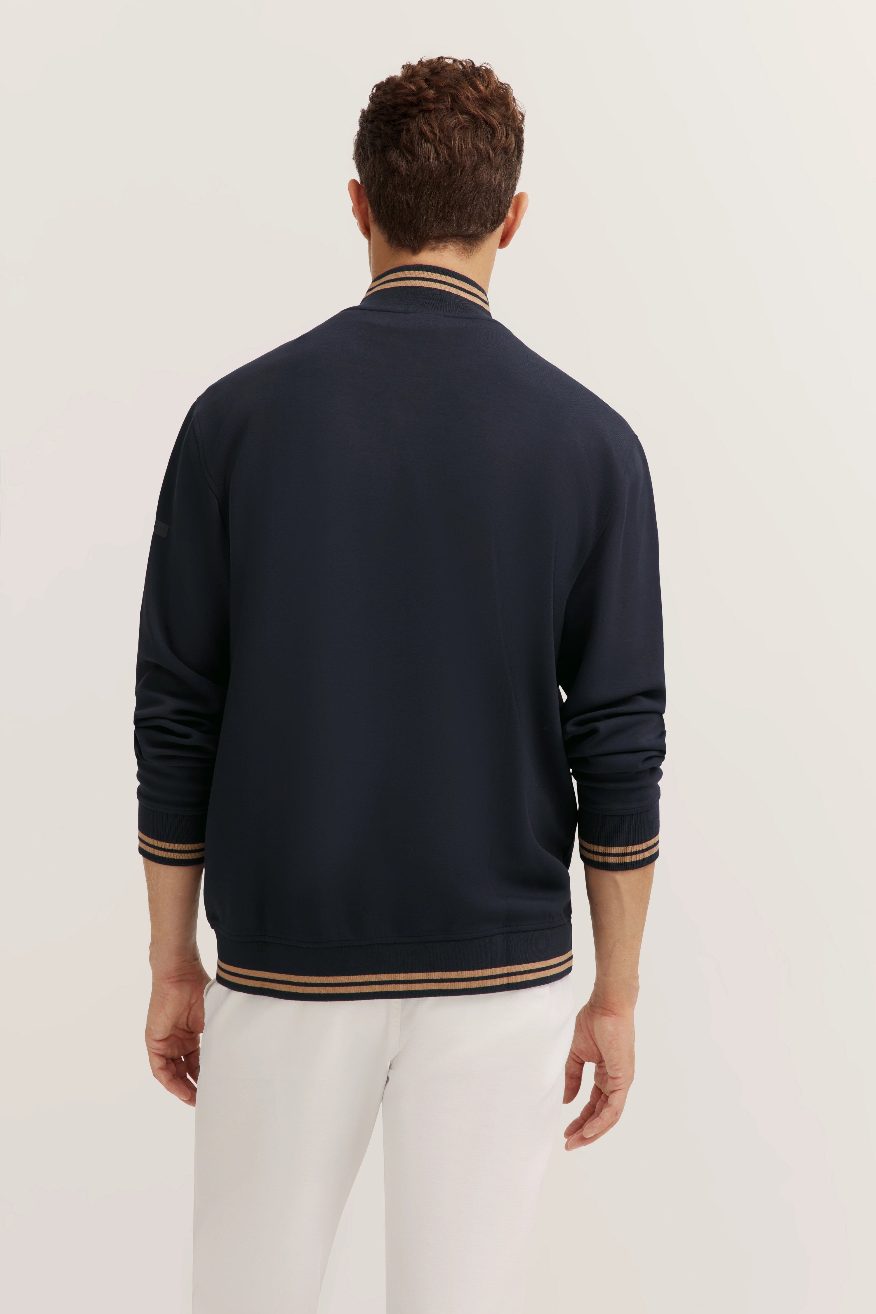 Navy bomber jacket by bugatti, back view, casual model, white background.