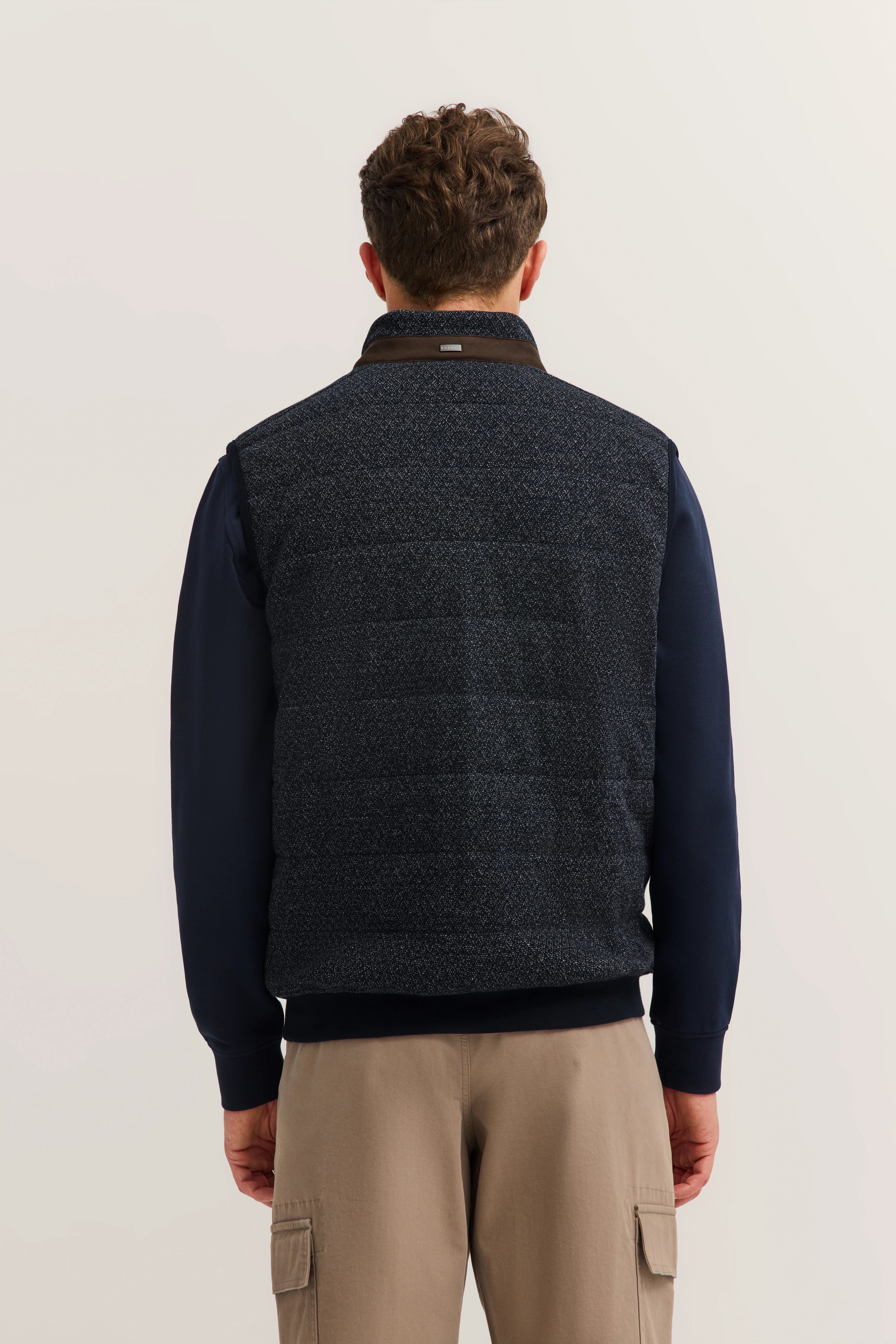 bugatti man in navy vest and beige chinos, back view, casual and stylish.