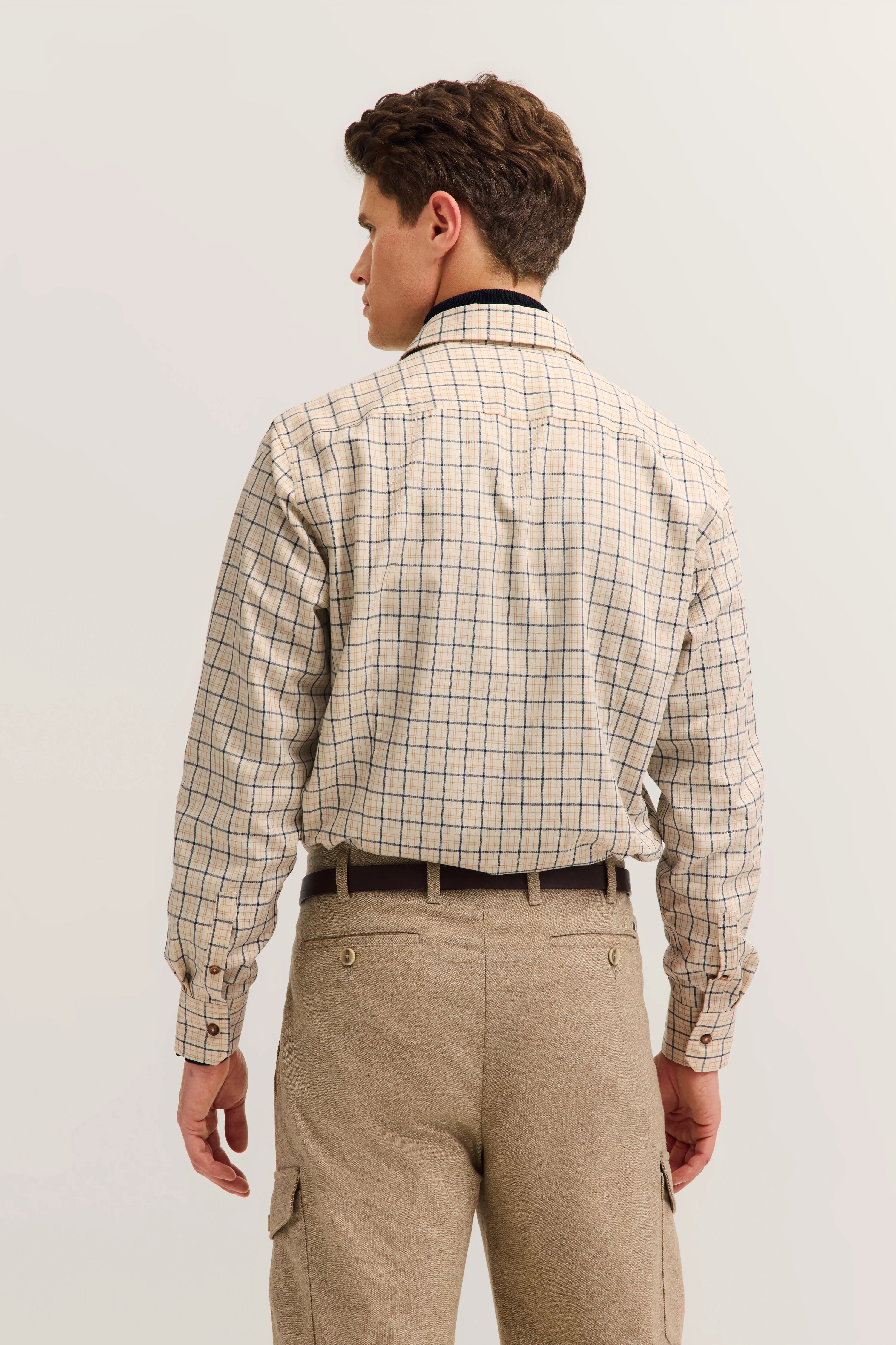 Beige check shirt with matching pants, back view, relaxed pose.