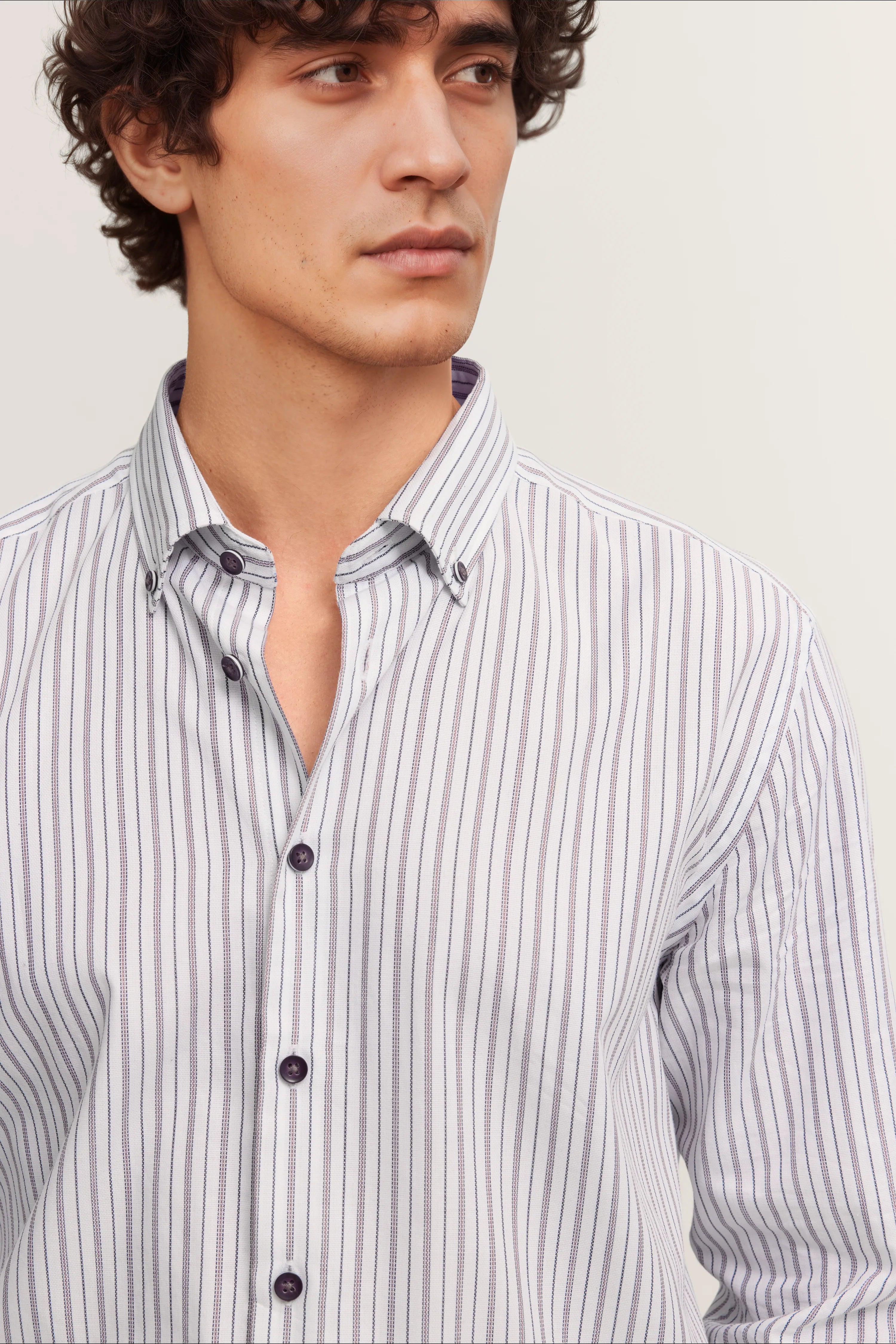 bugatti Hemd mit lila Streifen auf weiß, Modelbild, legeres Posing, stilvoll und zeitlos.