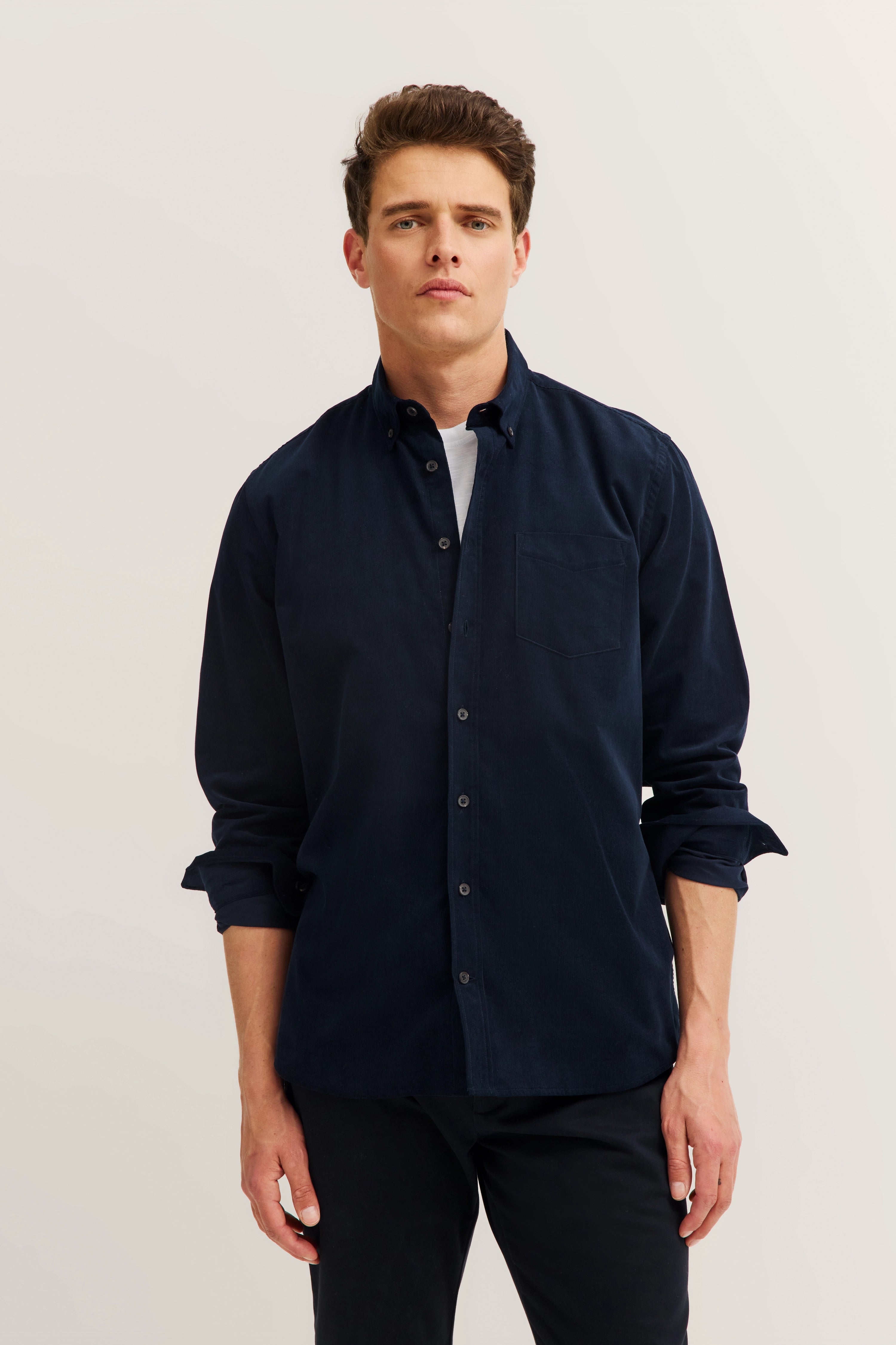 Navy blue bugatti shirt, casual model, relaxed pose, urban style.