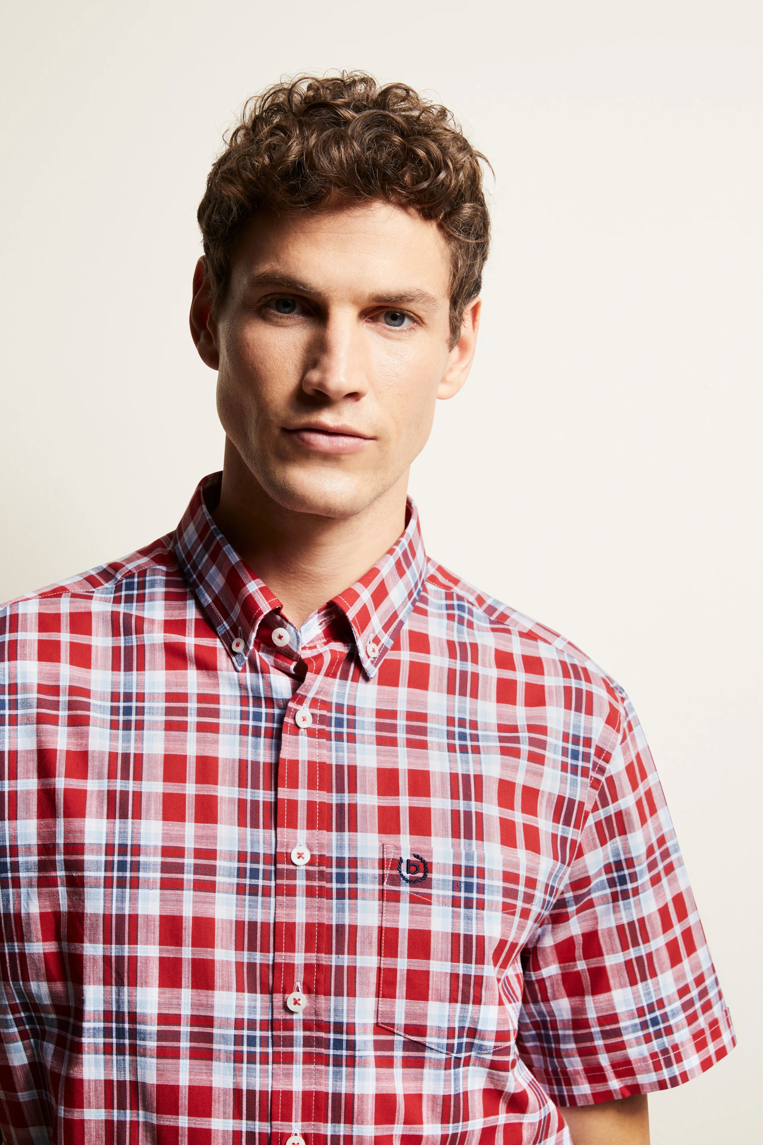bugatti red and blue checked shirt on model, casual pose, bust shot.