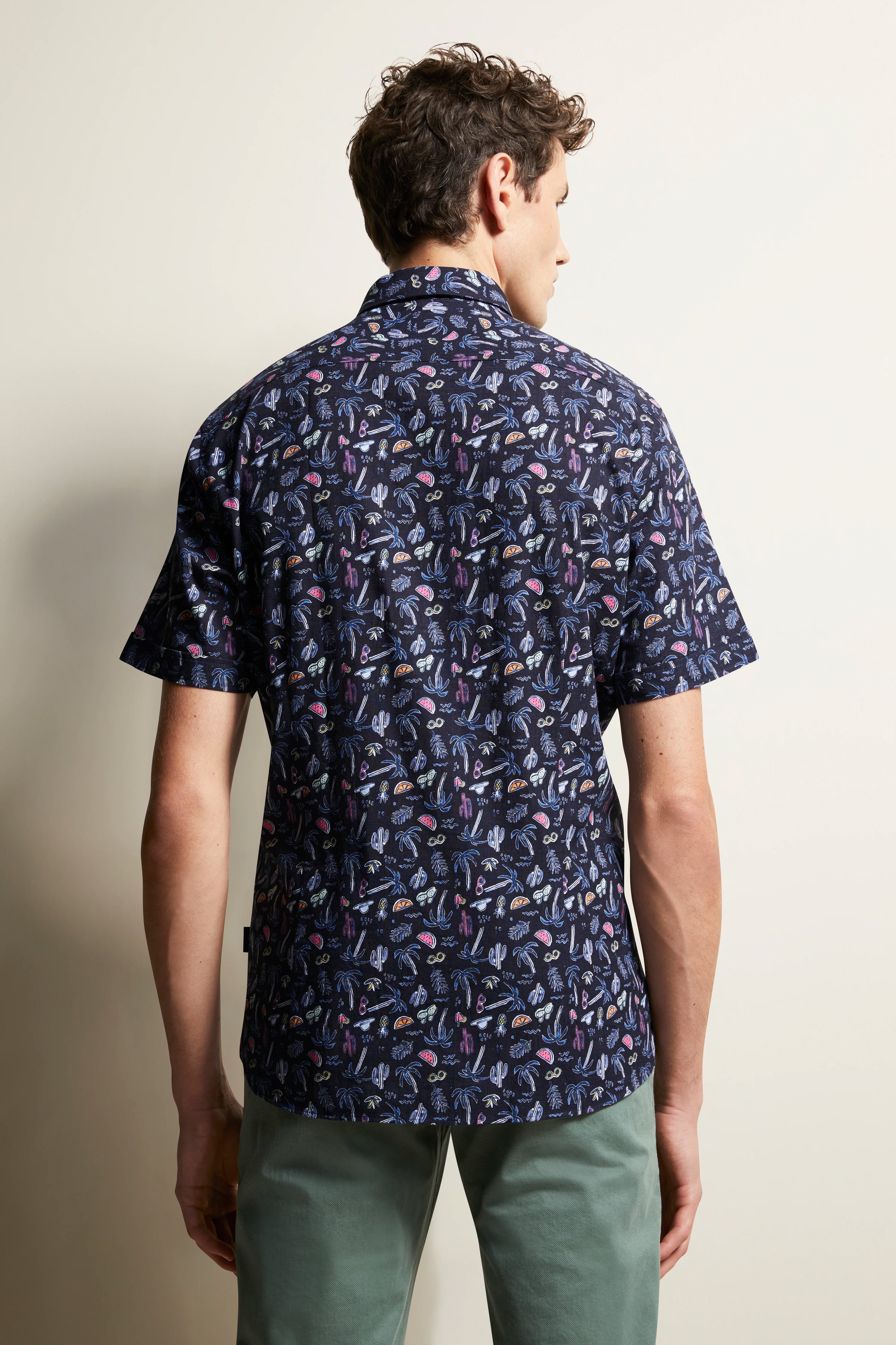 bugatti shirt with colorful pattern, dark blue, back model view, green pants, casual.