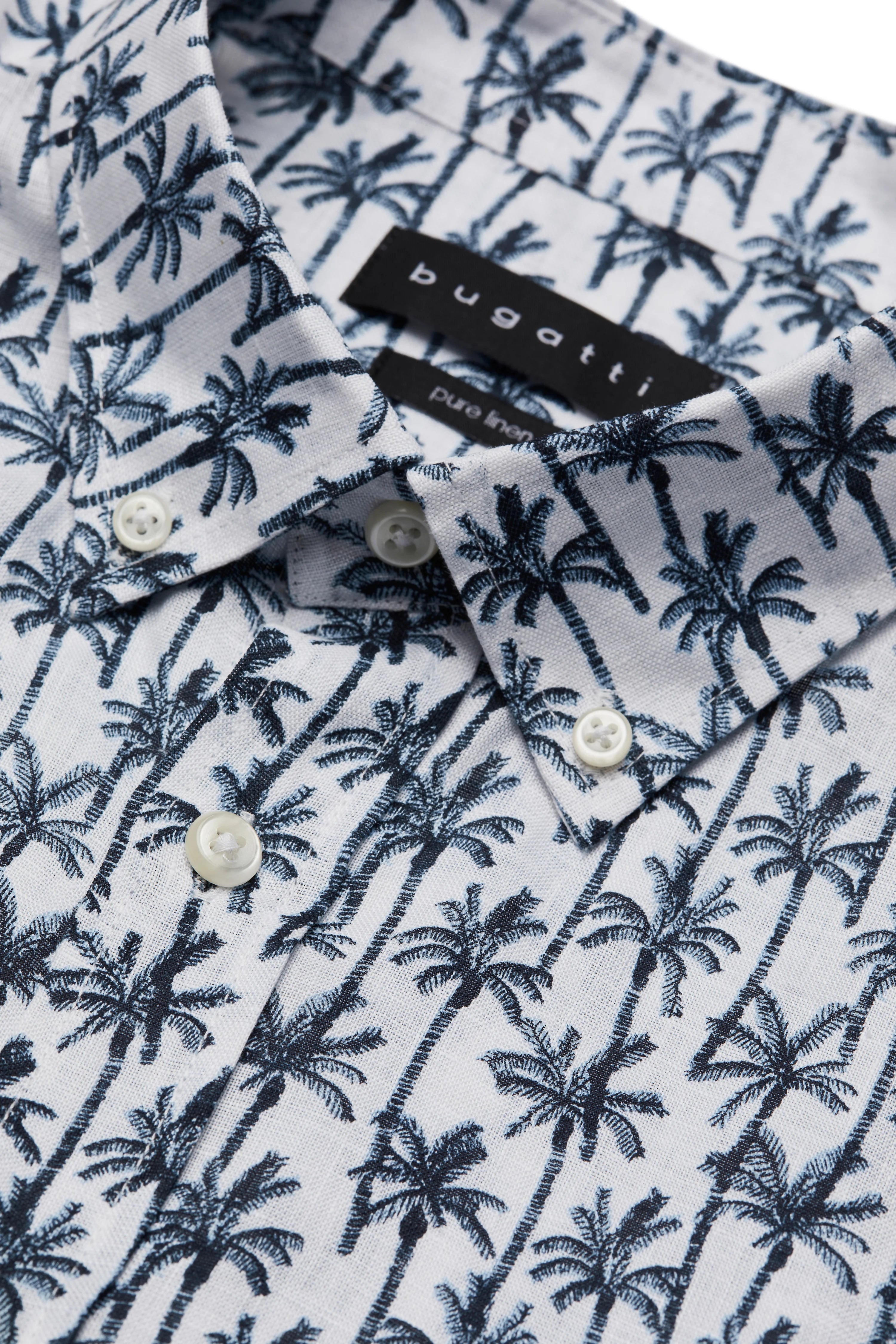 bugatti shirt with blue-white palm pattern, close-up, casual design.